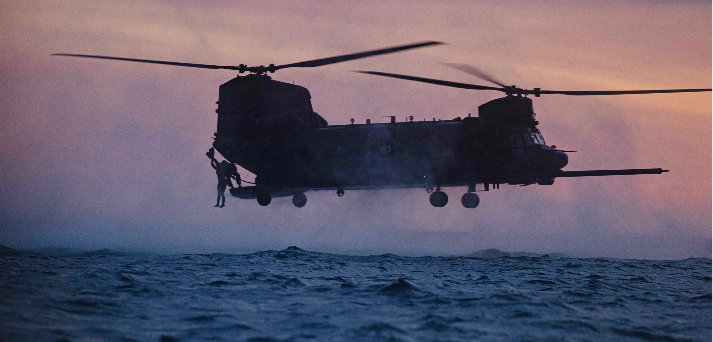 A U.S. Marine with Bravo Company, 1st Reconnaissance Battalion, 1st Marine Division, jumps from a U.S. Army MH-47 Chinook helicopter with 160th Special Operations Aviation Regiment during helocast training as part of Steel Knight 23 off the coast of Marine Corps Base Camp Pendleton, California, Dec. 2, 2022. Helocasting is a maritime insertion method for small units during amphibious operations. Steel Knight is an annual combined arms live-fire exercise which ensures 1st MARDIV is optimized for naval expeditionary warfare in contested spaces, and is purpose-built to facilitate future operations afloat and ashore. (U.S. Marine Corps photo by Cpl. Willow Marshall)