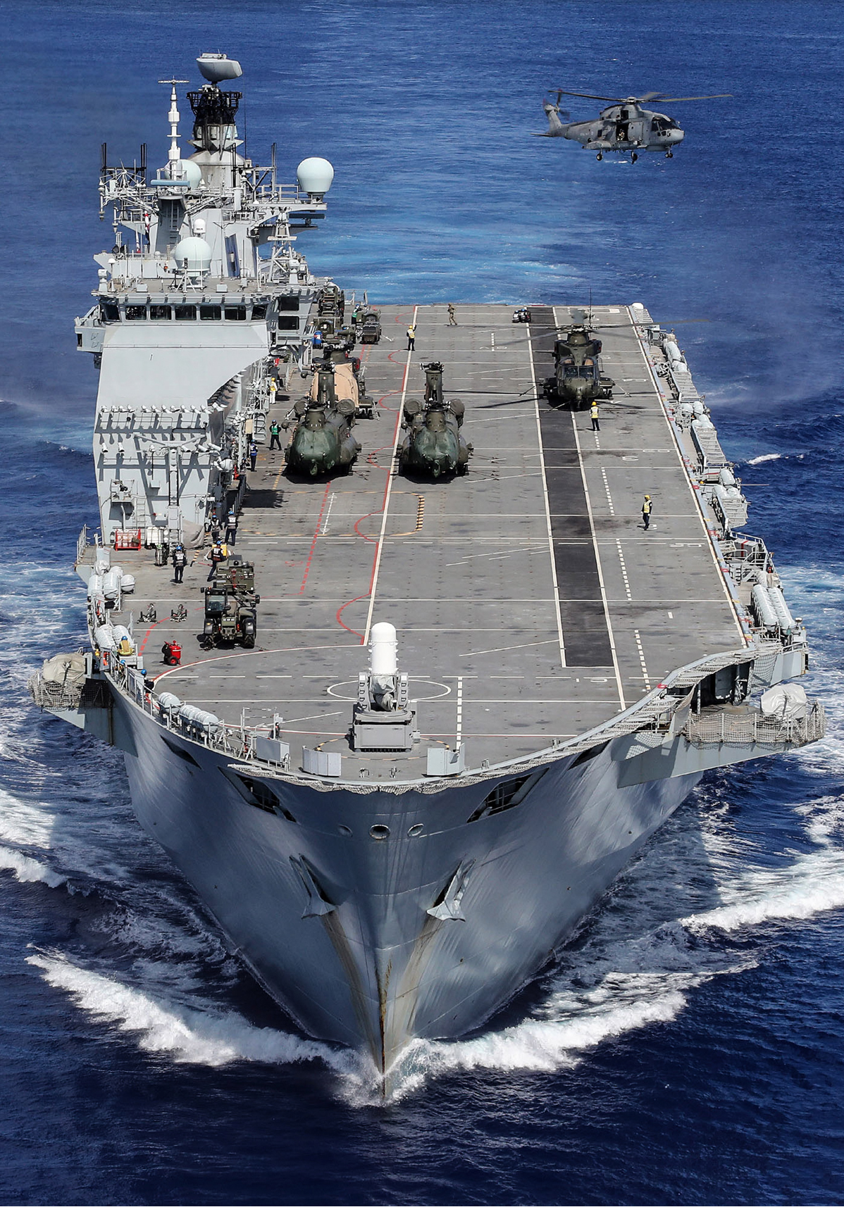 HMS Ocean's embarked helicopters carry out training whilst heading for the Caribbean during Op RUMAN. In 2017 HMS OCEAN was one of the ships to be tasked to support the government's Humanitarian Aid and Disaster Relief (HADR), providing assistance in the aftermath of Hurricanes IRMA, JOSE and MARIA in the Caribbean.   The Royal Navy's flagship, a large helicopter carrier, HMS Ocean was diverted from her NATO deployment in the Mediterranean to provide assistance.  The HADR team on board HMS OCEAN included Royal Marines, Medics, and Engineers, specialising in electronic, mechanical, structural disciplines as well as damage control experts.   HMS OCEAN carried a large tailored Air Wing of Royal Navy and Joint Helicopter Command Helicopters and with four landing craft and was able to make a significant contribution to the recovery and reconstruction effort in the region.  This image was part of the 2018 Royal Navy Photographic Competition, The Peregrine Trophy. 