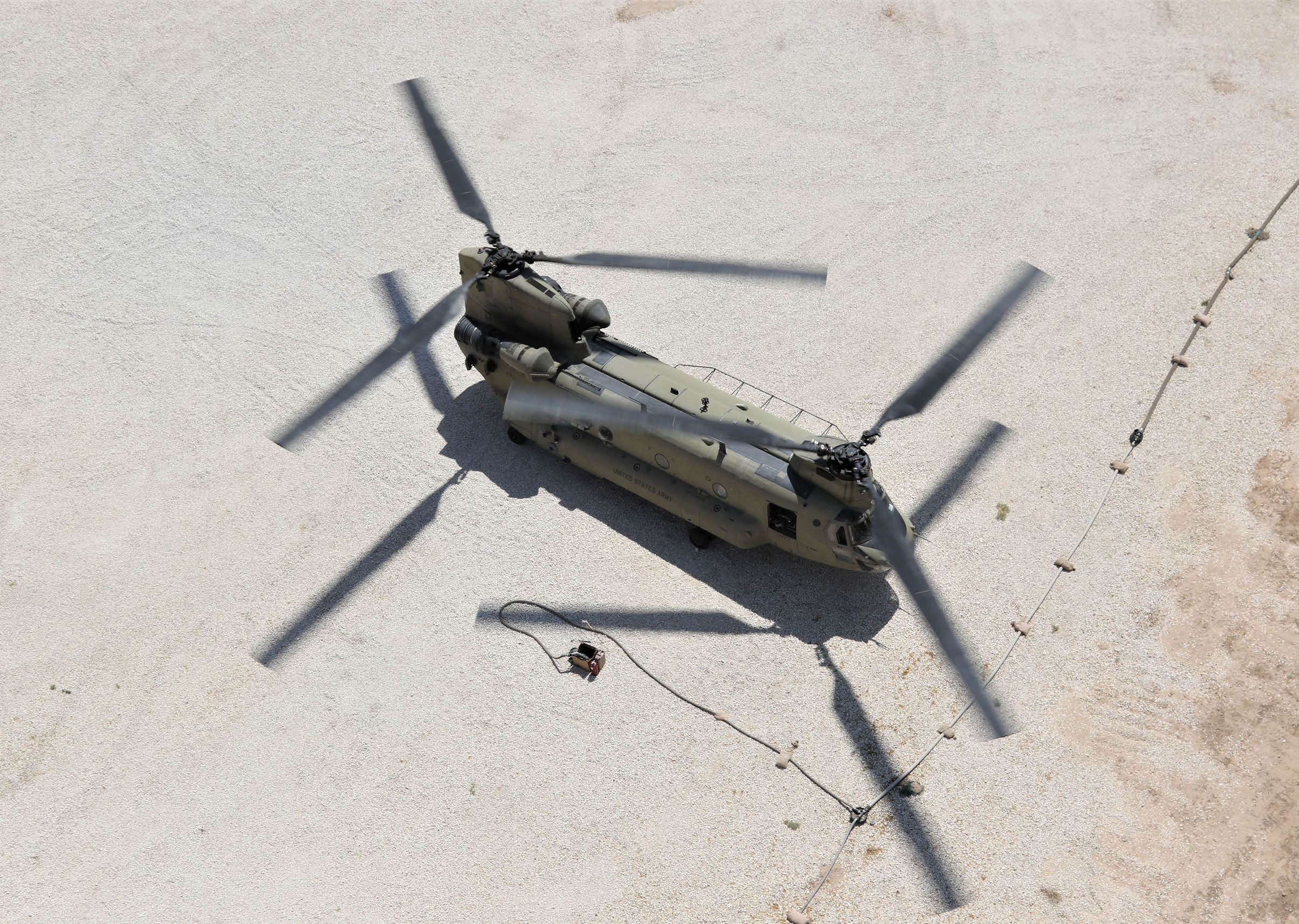 A Task Force Phoenix CH-47 Chinook helicopter from B Company, 1st Battalion, 171st Aviation Regiment (General Support Aviation Battalion), sits on the landing pad at a forward operating base in Syria.