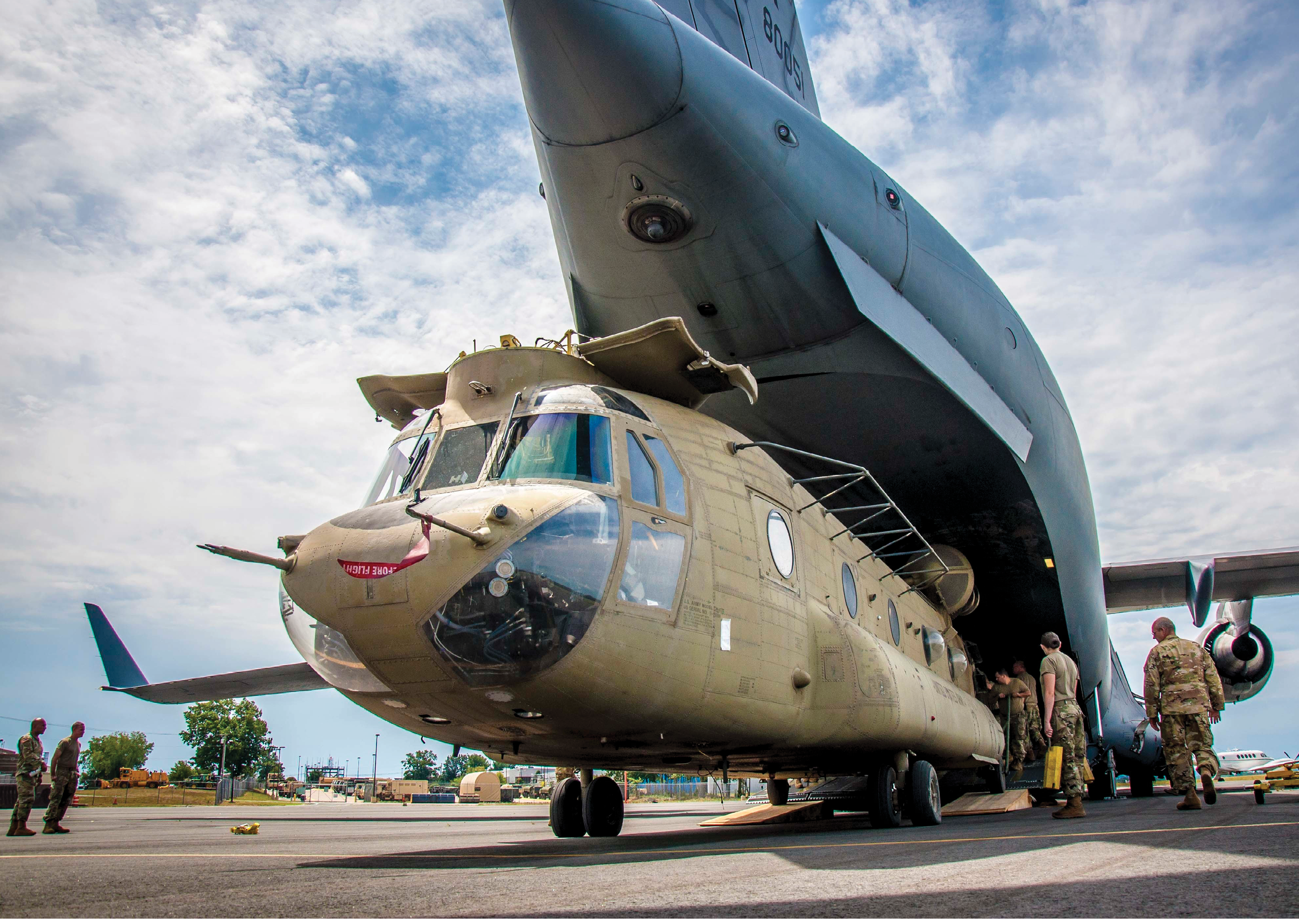 Soldiers assigned to the Connecticut National Guard unload a CH-47 Chinook helicopter belonging to 2nd Battalion, 104th Aviation Regiment from an Alaska National Guard C-17 Globemaster at the Army Aviation Support Facility in Windsor Locks, Conn. Aug. 6, 2020. The 2-104th recently completed an extended deployment to Afghanistan in support of Operation Freedom Sentinel.