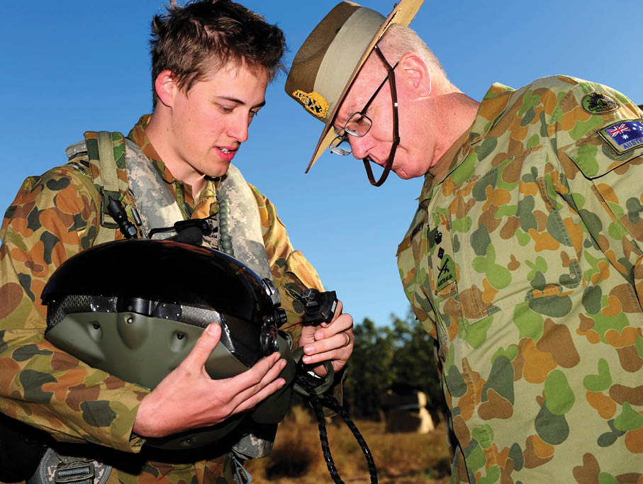 (L-R) 1st Aviation Regiment pilot Captain Adam Gyte shows General David Hurley, Chief of the Defence Force, some of the features of the TopOwl helmet-mounted sight display during Exercise Talisman Sabre 2011. Mid-caption: The Chief of the Defence Force, General David Hurley, AC, DSC, flew into the Shoalwater Bay training area this week to visit Australian and United States personnel currently conducting Exercise Talisman Sabre 2011.   General Hurley first met US exercise commanders at sea on the USS Germantown.  Once ashore, General Hurley met with the Commander of Joint Operations, Lieutenant General Ash Power, to discuss the progress of TS11. Throughout the day he attended briefings with the Australian commanders of the Coalition and Opposition forces and also received demonstrations on the Torch Battle Management System, currently being trialled on TS11.   The day concluded with a visit to a detachment of Australian Army Tiger Armed Reconnaissance Helicopters currently operating from the Plains airfield within Shoalwater Bay training area. During the visit, General Hurley was shown over the aircraft by pilots from the 1st Aviation Regiment.   General Hurley was appointed Chief of the Defence Force (CDF) on 4 July 2011. The CDF has primary responsibility for the command of the Australian Defence Force (ADF). The CDF is also principal military adviser to the Minister for Defence and provides advice on matters that relate to military activity, including military operations.   Exercise Talisman Sabre (11–29 July 2011) is a major bilateral exercise designed to train Australian and United States forces in planning and conducting combined operations across the full spectrum of military full spectrum of military operations from conventional conflict to peacekeeping and humanitarian assistance in order to improve Australian–US combat readiness and interoperability.  Photograph by CPL Raymond Vance 1st Joint Public Affairs Unit