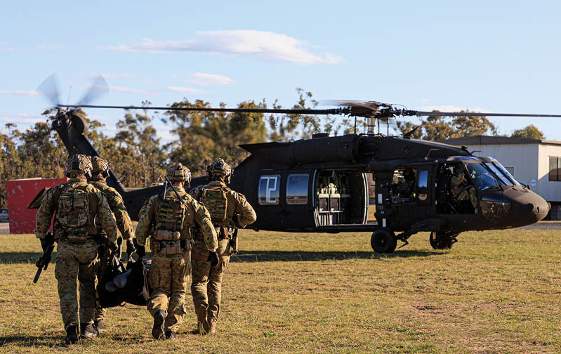 Australian Army soldiers and aviators conduct helicopter insertion and extraction training as part of UH-60M Black Hawk introduction into service activities.