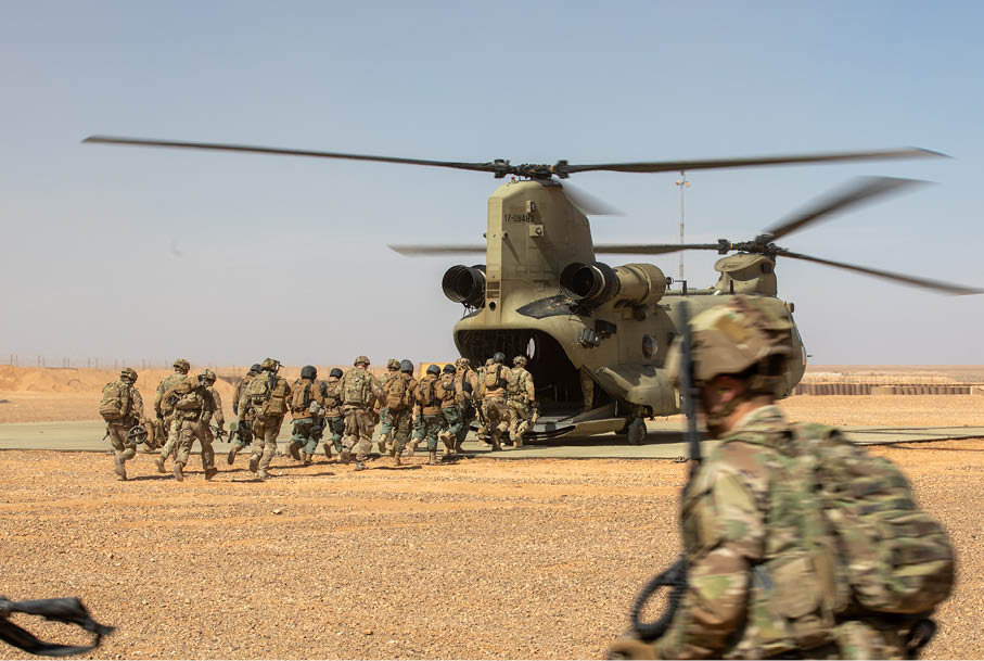 Syrian partner forces and U.S. Army Soldiers assigned to the 10th Mountain Division, Task Force Armadillo, load a CH-47 Chinook helicopter during air assault training at Al-Tanf Garrison, Syria, on Feb. 25, 2025. The training reflects the Coalition's ongoing efforts to enhance the capabilities of partner forces and strengthen partnerships in the fight against ISIS. The Coalition is committed to advising, assisting, and enabling partner forces to defeat ISIS and maintain regional security and stability. (U.S. Army photo by Staff Sgt. Fred Brown)