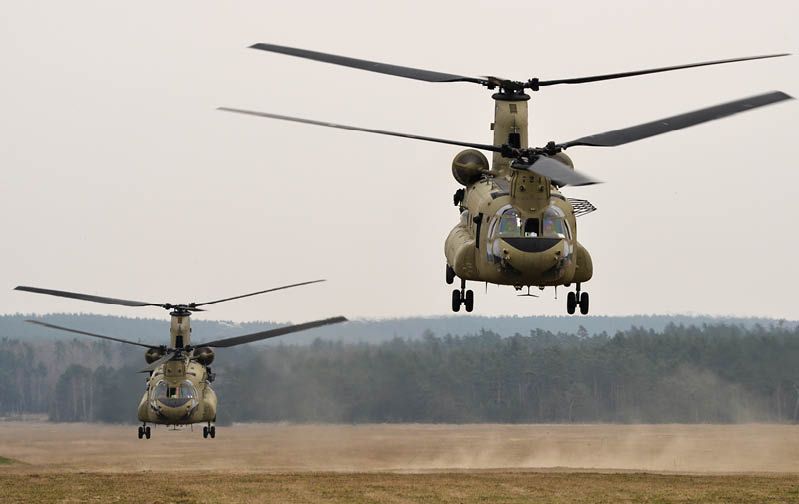 Two 12th Combat Aviation Brigade CH-47 Chinooks lift off Bunker Drop Zone in Grafenwoehr after picking up paratroopers, assigned to 1st Battalion, 503rd Infantry Regiment, 173rd Infantry Brigade Combat Team (Airborne) during a combined-arms live-fire exercise March 28, 2014. The combined-arms live-fire exercise was conducted at the 7th Army Joint Multinational Training Command’s Grafenwoehr and Hohenfels Training Areas in order to prepare the 12th Combat Aviation Brigade to deploy to Afghanistan to provide medical evacuation and combat support to the NATO International Security Assistance Force mission. (U.S. Army photo by Visual Information Specialist Markus Rauchenberger/released)