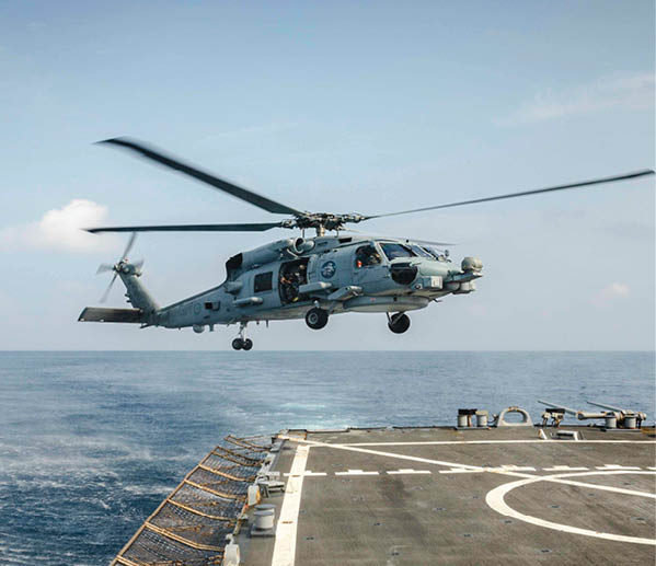 An MH-60R Sea Hawk helicopter from the Royal Australian Navy Anzac-class frigate HMAS Ballarat (FFH 155) prepares to land on the flight deck aboard the Arleigh Burke-class guided-missile destroyer USS John S. McCain (DDG 56) during flight operations. McCain is assigned to Destroyer Squadron Fifteen (DESRON 15), the Navy €™s largest forward-deployed DESRON and the U.S. 7th Fleet €™s principal surface force. (U.S. Navy photo by Mass Communication Specialist 2nd Class Markus Castaneda/Released)
