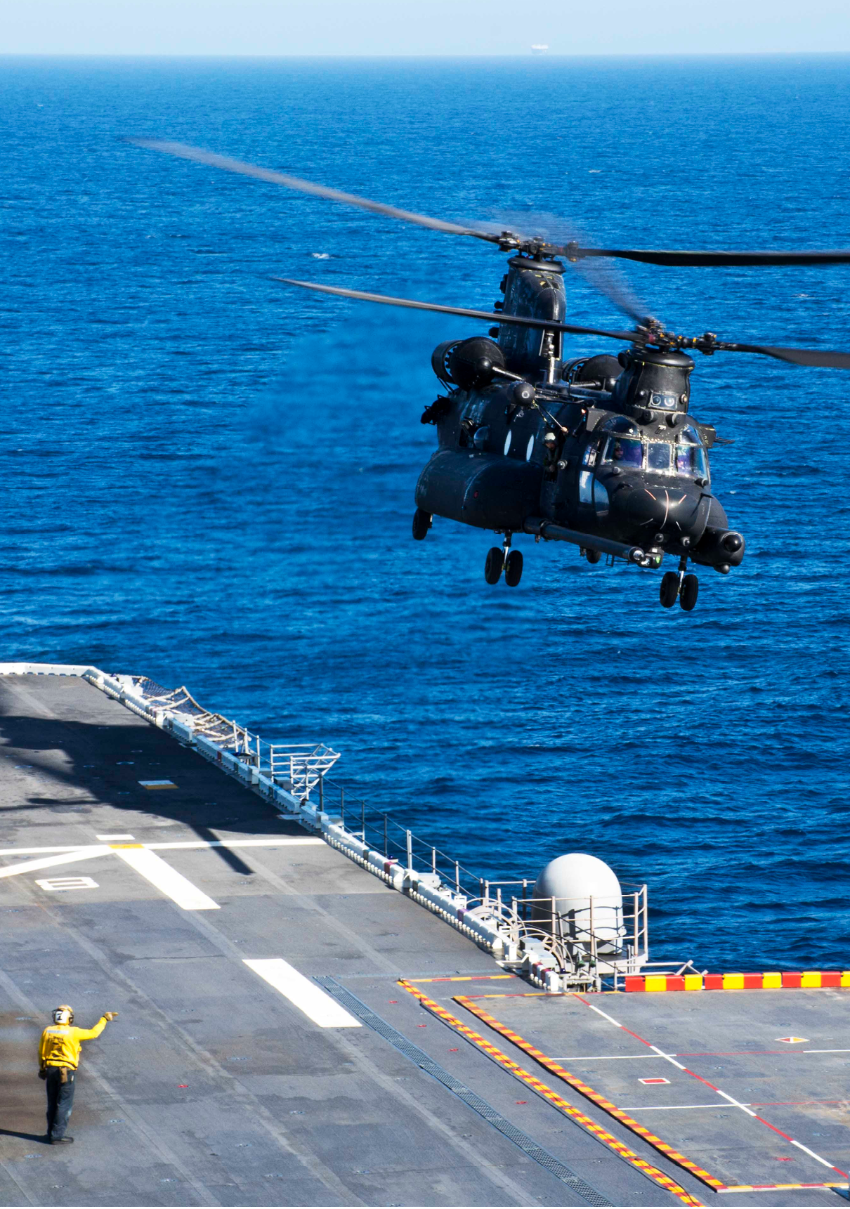 140428-N-EH218-052 PACIFIC OCEAN (April 28, 2014) Aviation Boatswain's Mate 3rd Class Michael Allen, a landing signal enlisted, launches an Army CH-47 Chinook helicopter assigned to Alpha Company Four, 160th Special Operations Aviation Regiment (SOAR) during deck landing qualifications aboard the amphibious assault ship USS Peleliu (LHA 5). Peleliu is conducting sea trials in preparation for an upcoming deployment. (U.S. Navy photo by Mass Communication Specialist Seaman Ryan J. Batchelder/Released)