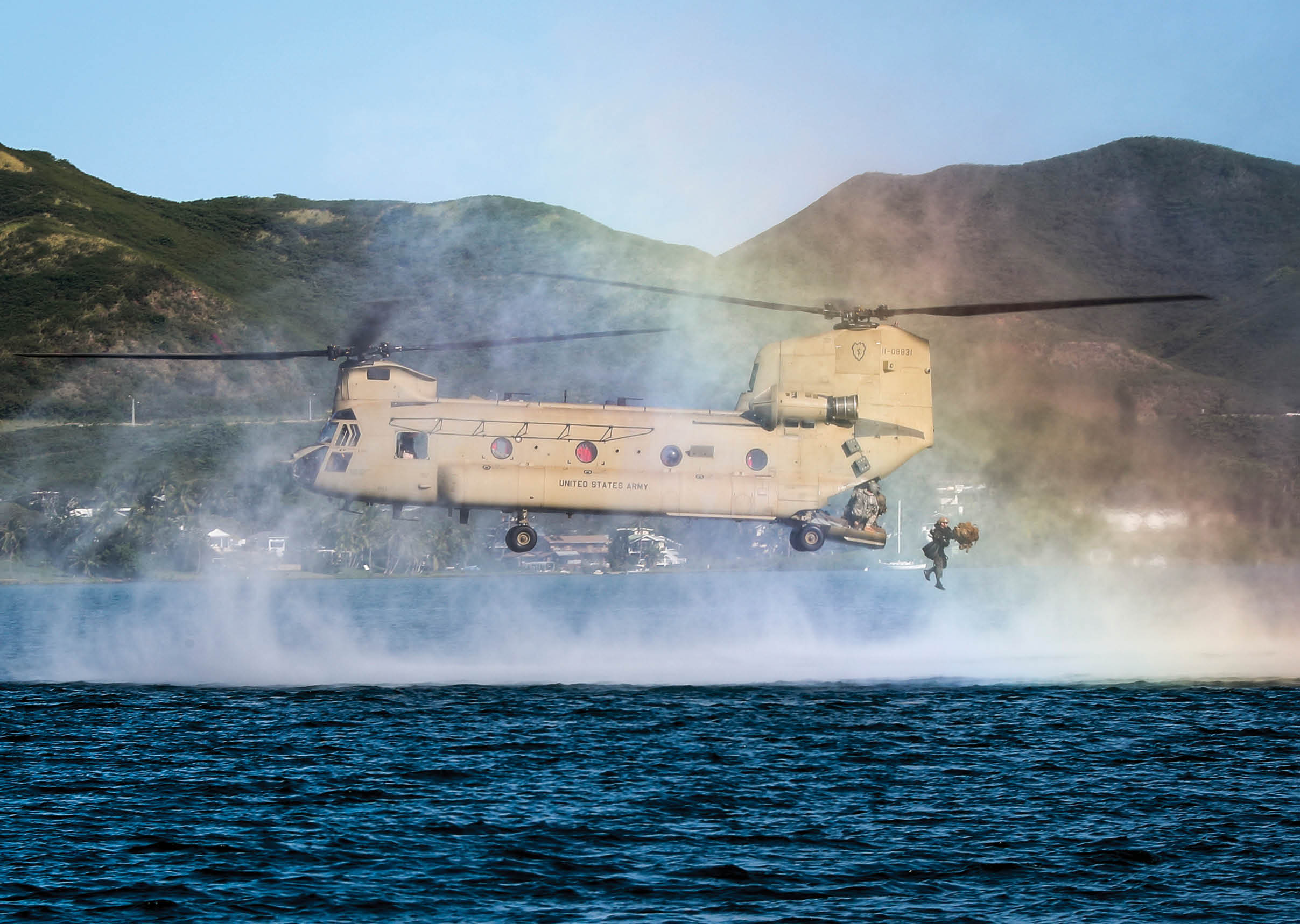 A U.S. Reconnaissance Marine jumps out of a CH-47 Chinook during helo-casting training operations, part of the Reconnaissance Team Leader Course held at Marine Corps Base Hawaii, April 24, 2017. The purpose of the Reconnaissance Team Leader Course is to provide the students with the required knowledge and skills needed to perform the duties of a Reconnaissance Team Leader. This course emphasizes planning, briefing and leading teams in patrolling, ground reconnaissance, and amphibious operations. (U.S. Marine Corps photo by Gunnery Sgt Ezekiel R. Kitandwe)
