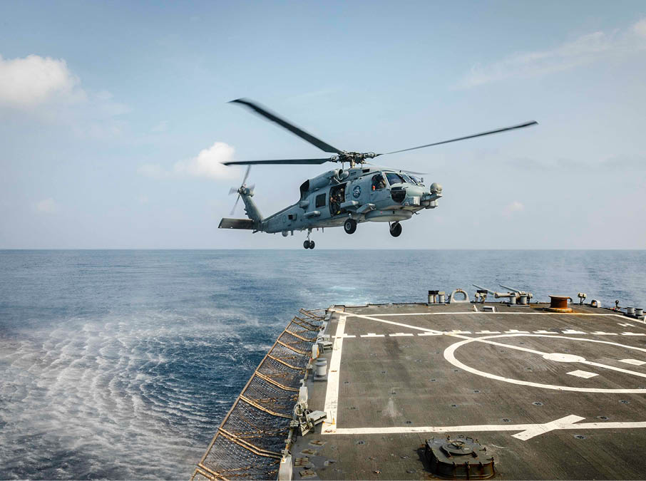 An MH-60R Sea Hawk helicopter from the Royal Australian Navy Anzac-class frigate HMAS Ballarat (FFH 155) prepares to land on the flight deck aboard the Arleigh Burke-class guided-missile destroyer USS John S. McCain (DDG 56) during flight operations. McCain is assigned to Destroyer Squadron Fifteen (DESRON 15), the Navy’s largest forward-deployed DESRON and the U.S. 7th Fleet’s principal surface force. (U.S. Navy photo by Mass Communication Specialist 2nd Class Markus Castaneda/Released)