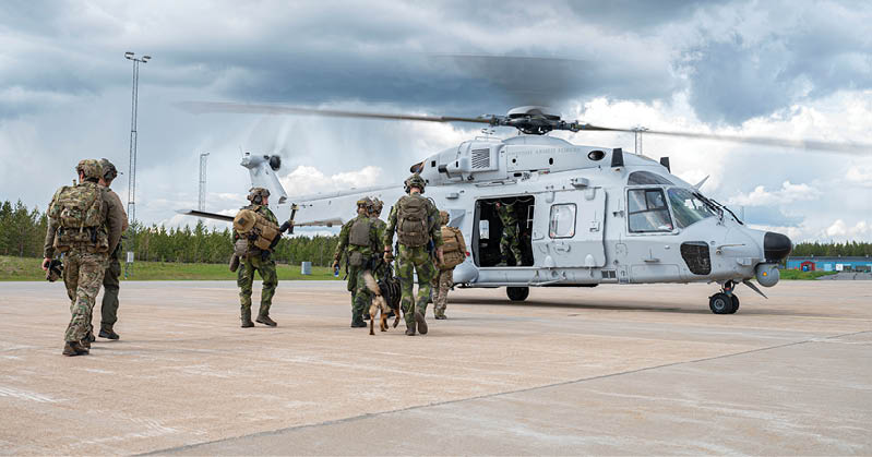 U.S. Air Force Airmen assigned to the 57th Rescue Squadron based out of Aviano Air Base, Italy, and Swedish air force rangers assigned to the 17th Wing based out of Ronneby, Sweden, load onto an NH-90 helicopter during bilateral training at Kallax Air Base, Sweden, June 11, 2025. The team was flown to a mock crash site where they located and rescued a simulated downed pilot. (U.S. Air Force photo by Staff Sgt. Brooke Rogers)