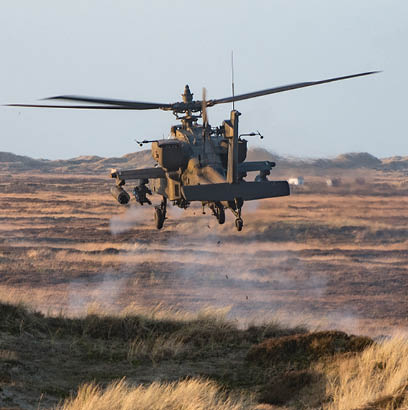 An AH-64, from 1st Battalion, 3rd Aviation Regiment, 12th Combat Aviation Brigade, engages targets with the 30 mm M230 chain gun on a live-fire range on Oksbol Training Area, Denmark, Dec. 10, 2015. (U.S. Army photo by Sgt. Thomas Mort)