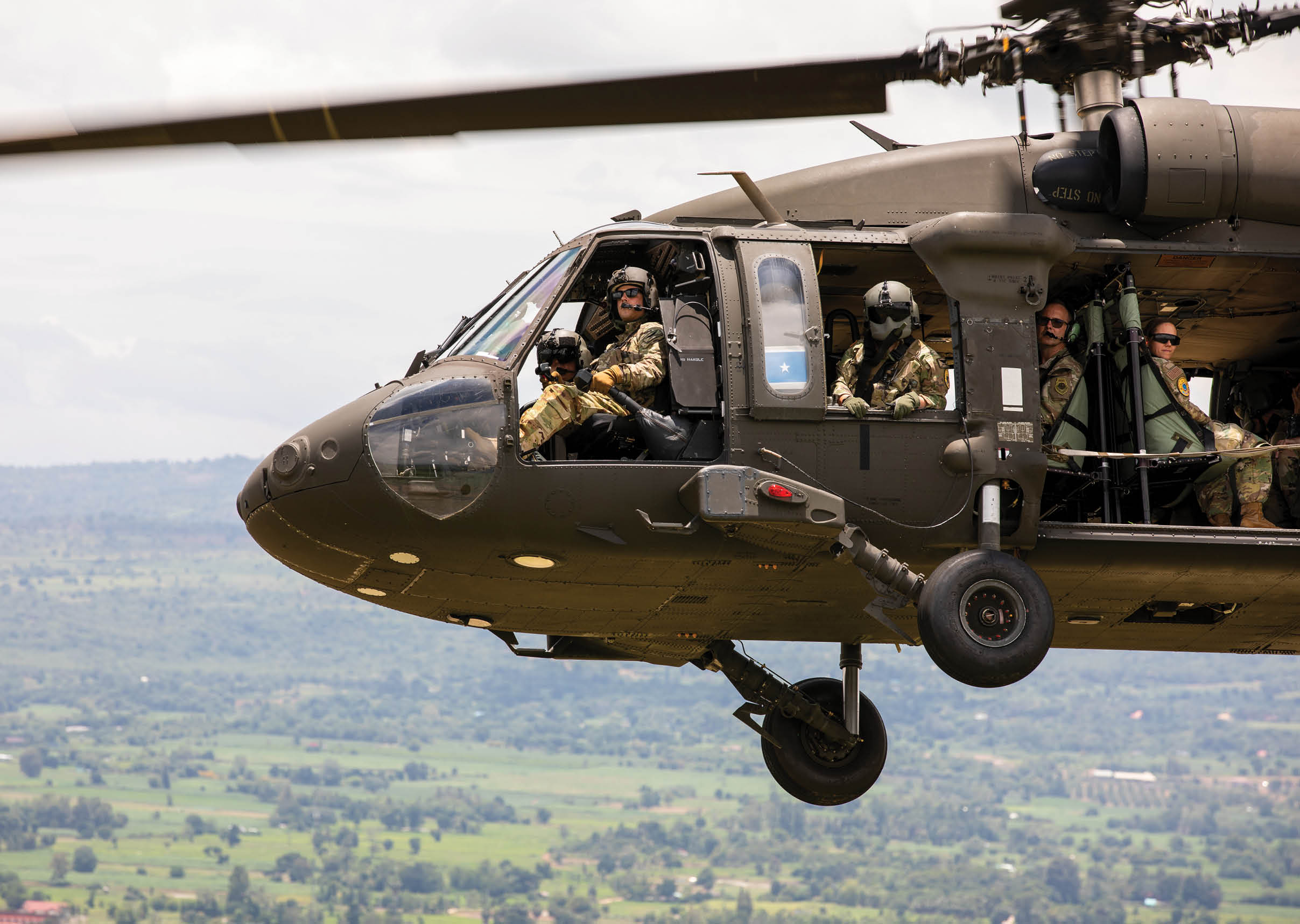U.S. Air Force Brig. Gen. Kenneth Borchers, Washington Air National Guard commander, rides in a Washington Army National Guard UH-60M Black Hawk piloted by U.S. Army Chief Warrant Officer 3 Jarin Trakel, a standardization pilot assigned to Charlie Company, 1st Battalion, 140th Aviation Regiment, 96th Aviation Troop Command, during an Enduring Partners 2025 training event over Nakhon Ratchasima, Thailand, Aug. 26, 2025. Enduring Partners gives U.S. and Thai service members an opportunity to strengthen relationships and validate and enhance interoperability through training, air-to-air refueling and ground-controlled interception. (U.S. Army National Guard photo by Sgt. Matthew Sprowl)