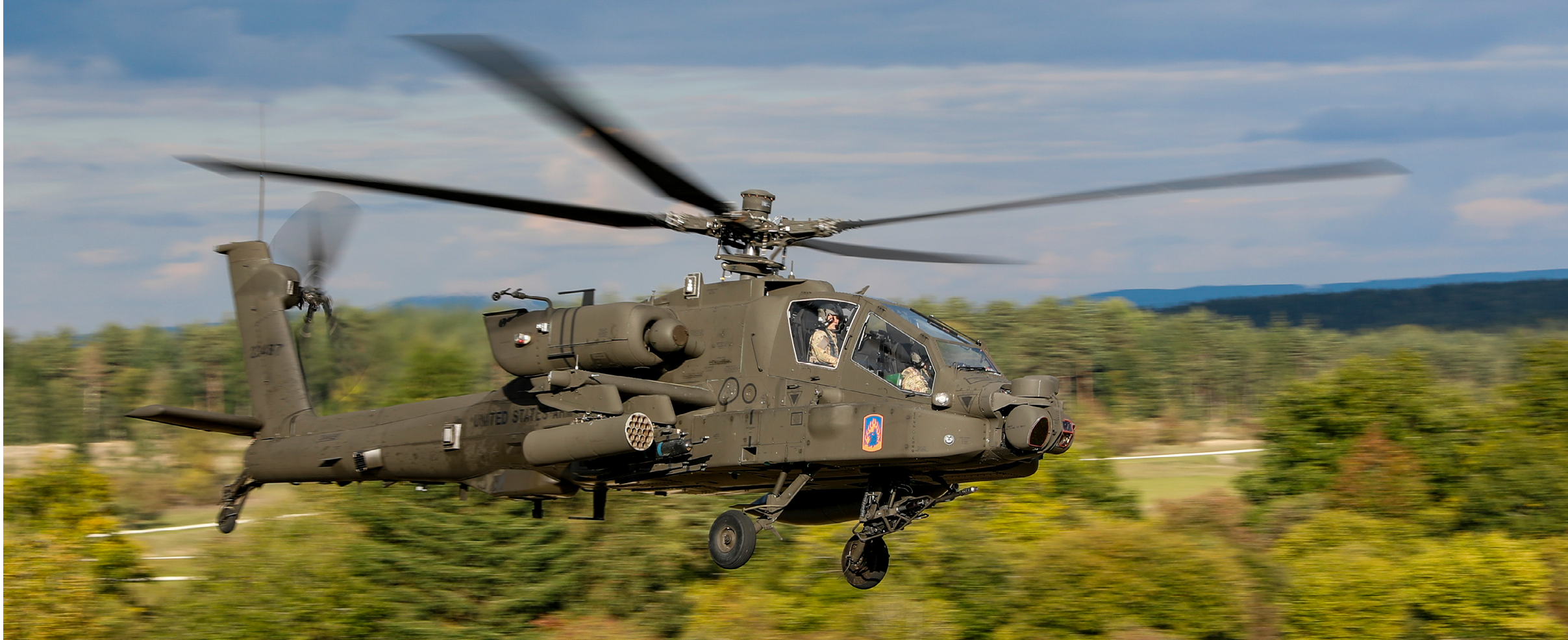 An AH-64E Apache helicopter crew, assigned to 1-3 Attack Battalion, 12th Combat Aviation Brigade, conduct aerial gunnery training at Grafenwoehr Training Area, Germany, Oct. 2, 2025. Gunnery is essential for maintaining the combat readiness and lethality of the 1-3 Attack Battalion. It validates the proficiency of the AH-64E Apache crews, ensuring they can effectively employ their weapons systems to engage high-value targets. (U.S. Army photo by Spc. Josefina Garcia)