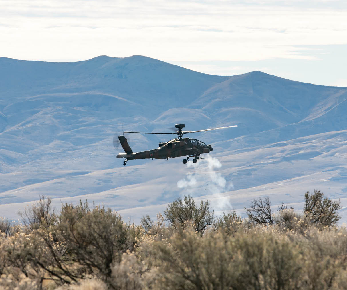 Aviators assigned to 1st Battle Helicopter Unit, Japanese Ground Self Defense Force, fire their 30mm chain gun from an AH-64 Apache helicopter at Yakima Training Center, Wash., on Dec. 3, 2021. The unit is conducting a combined arms training exercise with units from the 7th Infantry Division as part of Exercise Rising Thunder 21. (U.S. Army photo by Capt. Kyle Abraham, 16th Combat Aviation Brigade)