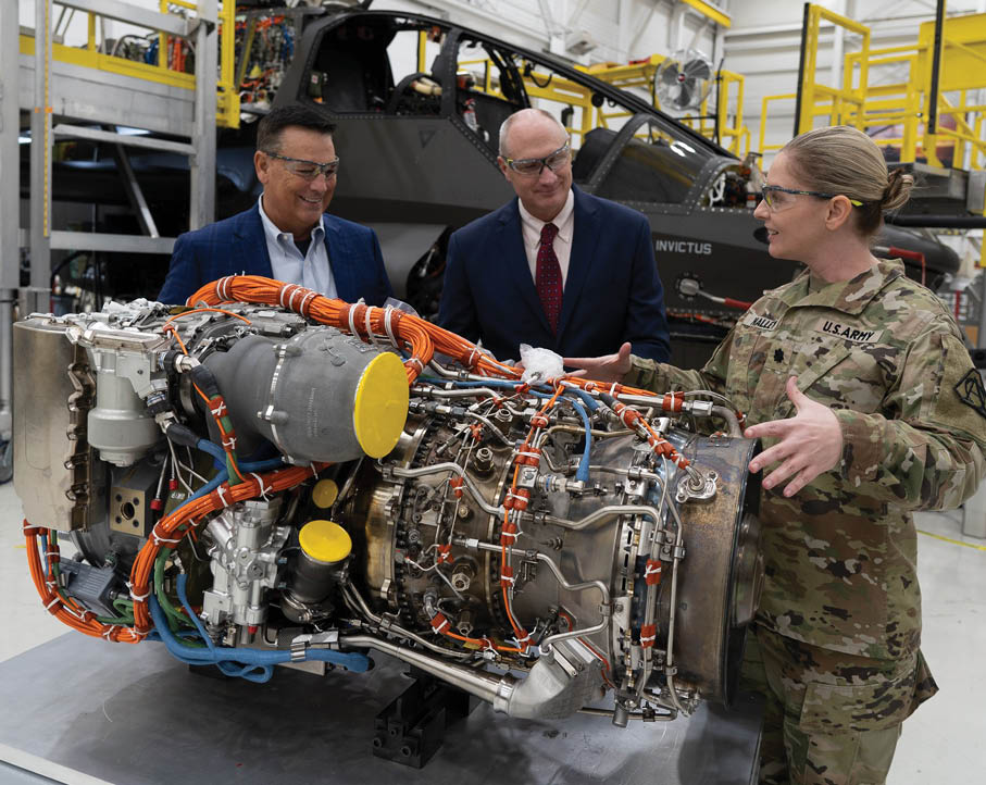 Lt. Col. Kelley Nalley, the Improved Turbine Engine Product Manager, (r) discusses the recently delivered T901 engine with Bell Senior Vice President Chris Gehler (l), and Richard Crabtree, PM Future Attack Reconnaissance Aircraft Program Integrator. The Army delivered the T901 Improved Turbine Engine to Bell’s Fort Worth, Texas plant on Oct. 20.