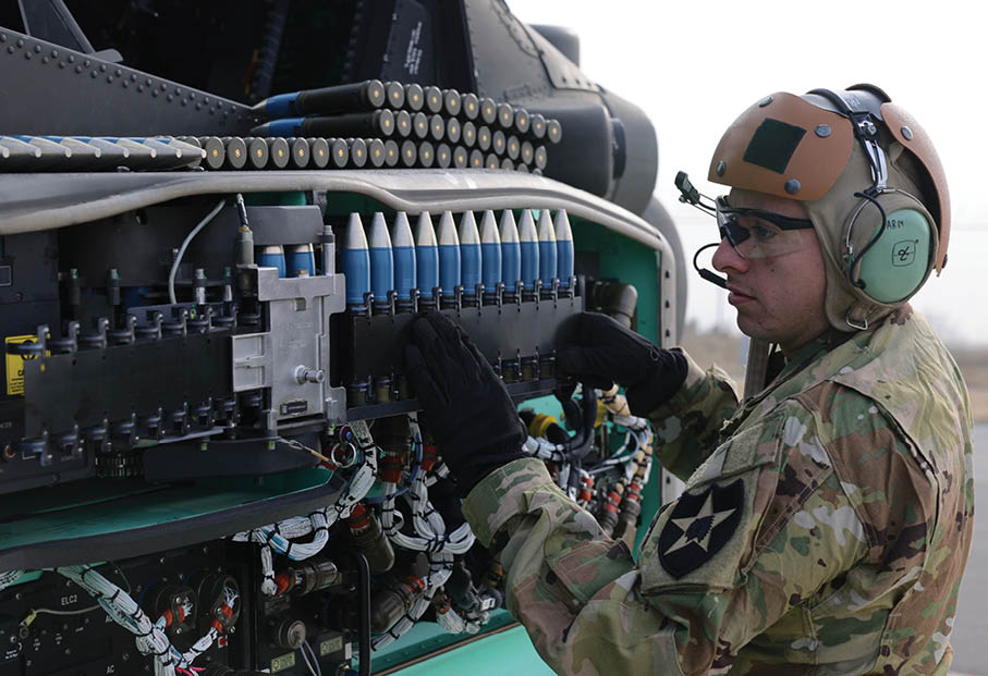 A Soldier assigned to 4th Battalion, 2nd Aviation Regiment, 2nd Combat Aviation Brigade, 2nd Infantry ROK-U.S. Combined Division loads 30mm autocanon ammunition on an AH-64E Apache helicopter during the Combined Joint Fires Coordination Exercise (CJFCX) on March 20, 2023 at Kunsan Air Force Base, South Korea. Apache helicopters can be armed with an assortment of munitions to include AGM-114 Hellfire missiles, Hydra 70 rockets and 30mm autocanon ammunition. The Apache helicopter gunnery of CJFCX coincides with Exercise Warrior Shield, a training exercise within the 2nd Infantry Division that employs Fight Tonight fundamentals and capabilities. (U.S. Army photo by Capt. Frank Spatt)