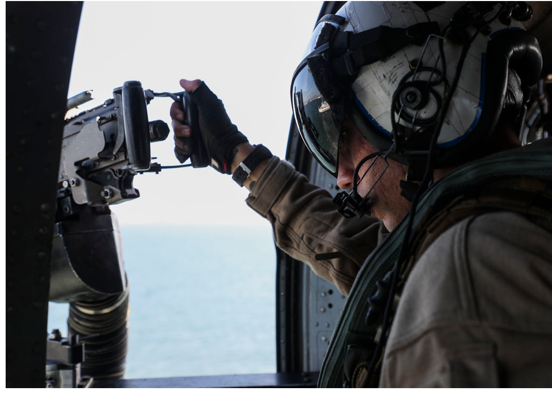 211026-N-OP825-1006 SAN CLEMENTE ISLAND (Nov. 26, 2021) Naval Aircrewman (Helicopter) 2nd Class David Cuadra of the “Wildcards” Helicopter Sea Combat Squadron (HSC) 23, mans a door gunner position in a MH-60S Knighthawk helicopter over San Clemente Island in support of Helicopter Advanced Readiness Program (HARP) exercises, Nov. 26. (U.S. Navy photo by Mass Communication Specialist 3rd Class Erica Higa)