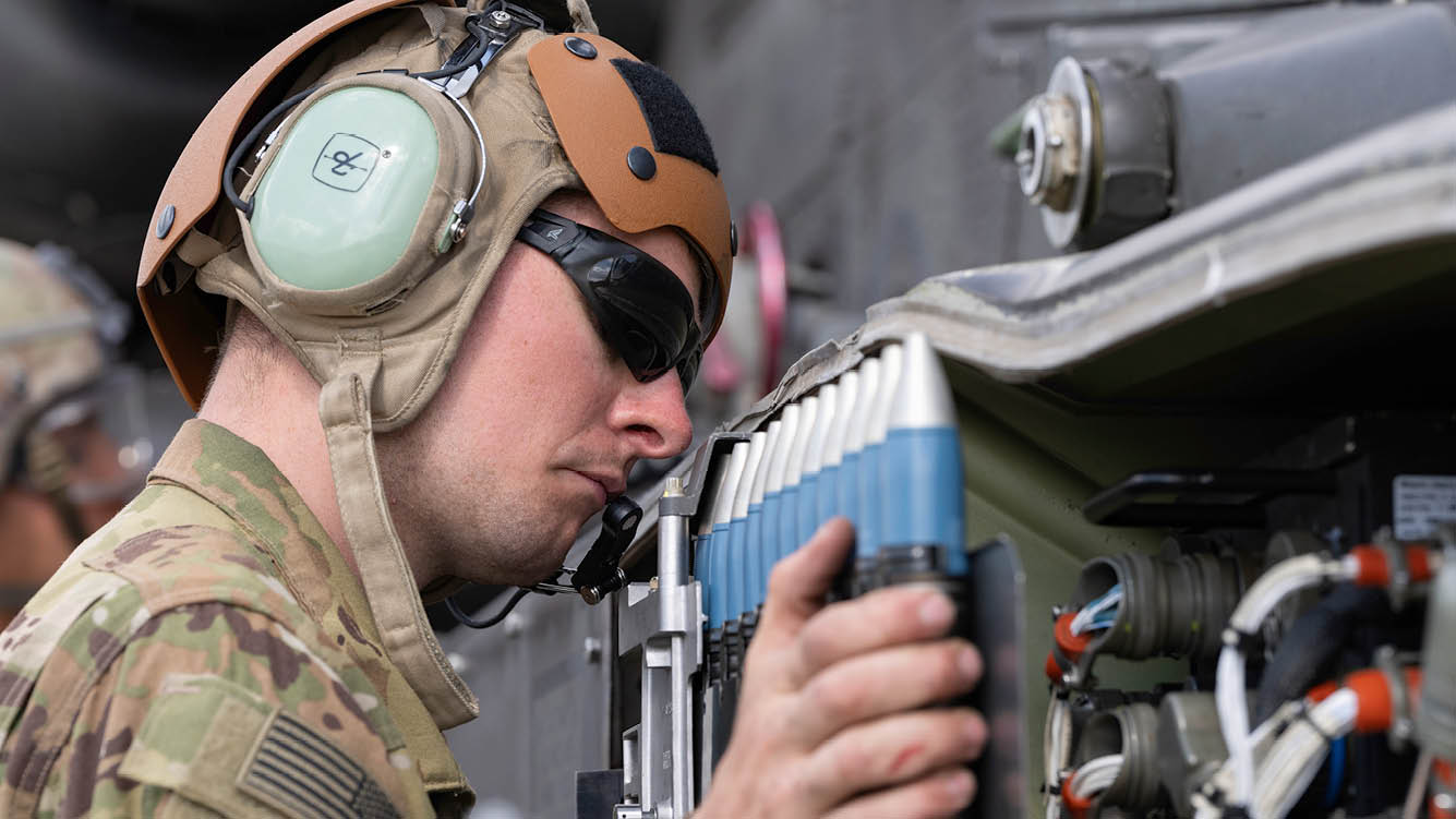 U.S. Army Spc. Peyton Ruder, an AH-64 armament, electrical, and avionics systems repairer assigned to 1st Battalion, 501st Aviation Regiment, Combat Aviation Brigade, 1st Armored Division, loads 30mm rounds into an AH-64D Apache attack helicopter during aerial gunnery qualification in Miros awiec, Poland, July 18, 2025. Aerial gunnery includes classroom instruction, simulator training, and live-fire exercises designed to validate aircraft weapon systems and evaluate aviator proficiency.