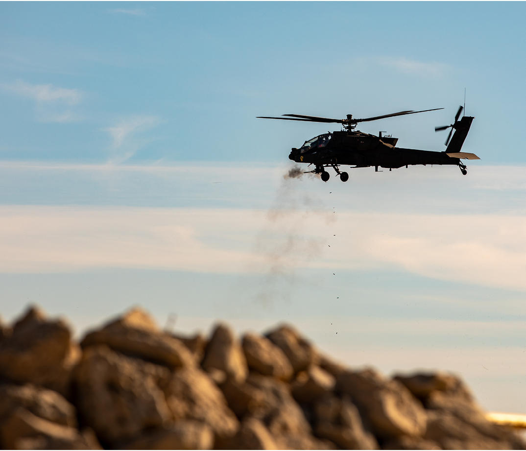 An AH-64 Apache helicopter with 1st Battalion, 227th Aviation Regiment, 1st Air Cavalry Brigade, 1st Cavalry Division fires machine gun rounds during a Combined Arms Live Fire exercise at Jack Mountain on Fort Cavazos, Texas, Jan. 22, 2025. CALFEX allows a maneuver company to incorporate indirect fires, aerial and sustainment assets to simulate realistic combat training to validate a unit's lethality as well as their readiness to deploy. (U.S. Army photo by Sgt. Nick LaRocco)