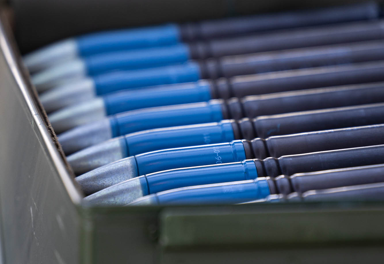An ammunition canister filled with 30-millimeter rounds sits on standby before being loaded into a U.S. Army AH-64E Apaches M230 cannon, Marine Corps Outlying Field Atlantic during a forward arming and refueling point exercise, Jan. 22, 2024. Soldiers used Marine Corps Air Station Cherry Point’s authentic training environment to refine tactical proficiency and adaptability. (U.S. Marine Corps photo by Lance Cpl. Matthew Williams)