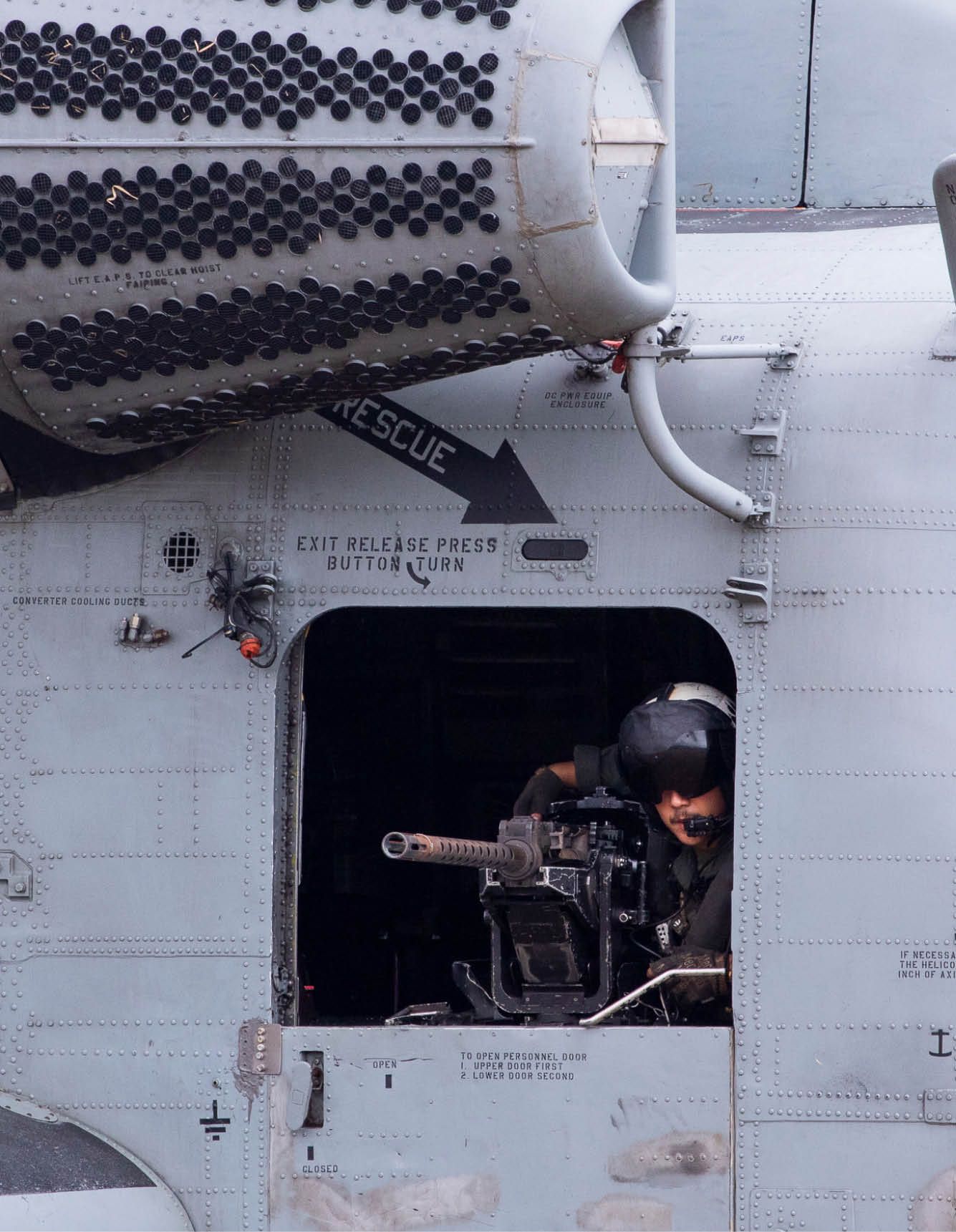 A U.S. Naval Aircrewman Tactical Helicopter observes out the gunner’s door of a U.S. CH-53E Super Stallion at Marine Corps Training Area Bellows, Hawaii, July 25, 2024. The aircraft and crew were supporting an air assault rehearsal executed by U.S. and allied partners for Exercise Rim of the Pacific (RIMPAC) 2024 to enhance interoperability between nations. Twenty-nine nations, 40 surface ships, three submarines, 14 national land forces, more than 150 aircraft and 25,000 personnel are participating in RIMPAC in and around the Hawaiian Islands, June 27 to Aug. 1. The world's largest international maritime exercise, RIMPAC provides a unique training opportunity while fostering and sustaining cooperative relationships among participants critical to ensuring the safety of sea lanes and security on the world's oceans. RIMPAC 2024 is the 29th exercise in the series that began in 1971. (U.S. Navy photo by Mass Communication Specialist 2nd Class Jacquelin Frost.)