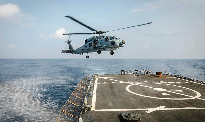 An MH-60R Sea Hawk helicopter from the Royal Australian Navy Anzac-class frigate HMAS Ballarat (FFH 155) prepares to land on the flight deck aboard the Arleigh Burke-class guided-missile destroyer USS John S. McCain (DDG 56) during flight operations. McCain is assigned to Destroyer Squadron Fifteen (DESRON 15), the Navy’s largest forward-deployed DESRON and the U.S. 7th Fleet’s principal surface force. (U.S. Navy photo by Mass Communication Specialist 2nd Class Markus Castaneda/Released)