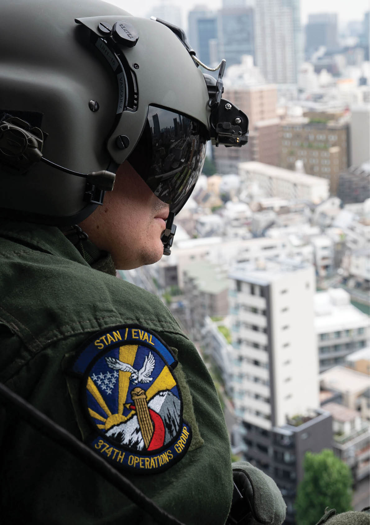U.S. Air Force Tech. Sgt. Jeovany Vasquez, 459th Airlift Squadron special mission aviator, surveys airspace out of a UH-1N Huey during its final operational flight at Yokota Air Base, Japan, Aug. 29, 2025. The two aircraft passed by Mt. Fuji, performed landings along the coast and made a stop at Akasaka Press Center before returning to base. (U.S. Air Force photo by Senior Airman Jacob Wood)