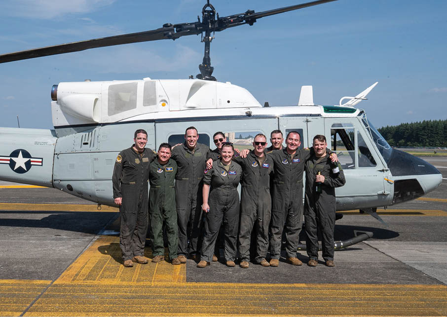 U.S. Air Force Airmen assigned to the 459th Airlift Squadron pose in front of a UH-1N Huey after its final operational flight at Yokota Air Base, Japan, Aug. 29, 2025. The UH-1N Huey has maintained a presence at Yokota for 45 years, providing aeromedical evacuation, search and rescue and priority airlift missions throughout the Pacific. (U.S. Air Force photo by Senior Airman Jacob Wood)