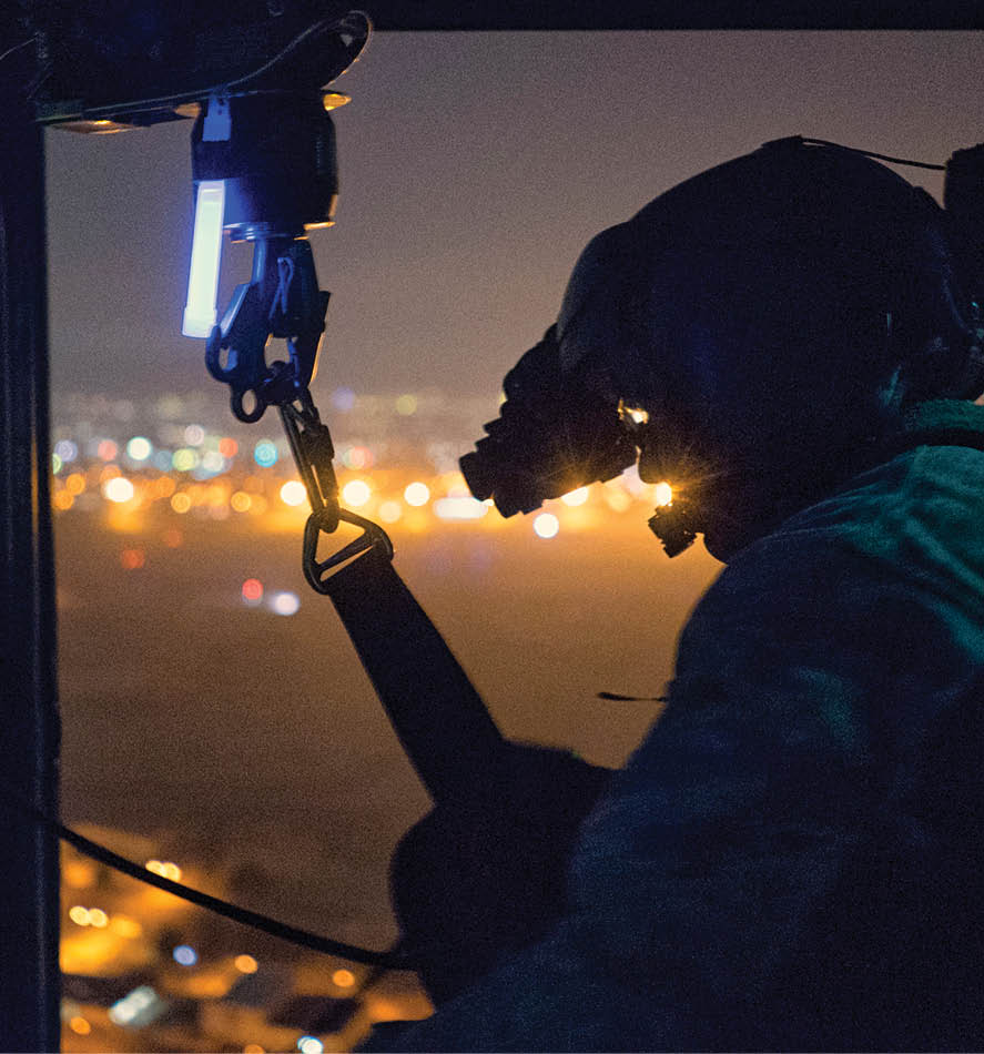 Tech. Sgt. Michael Wright, 459th Airlift Squadron UH-1N Huey flight engineer, reels in a UH-1N hoist cable at Yokota Air Base, Japan, Feb. 23, 2016. For 459th AS’s special missions aviators to become certified to operate the hoist, SMA instructors with the 512th Rescue Squadron, Kirtland Air Force Base, N.M., and the 36th RQS, Fairchild Air Force Base, Wash., arrived at Yokota to train alongside flight engineers. The requalification process included day and night hoist operations with instructor supervision. (U.S. Air Force photo by Airman 1st Class Delano Scott/Released)