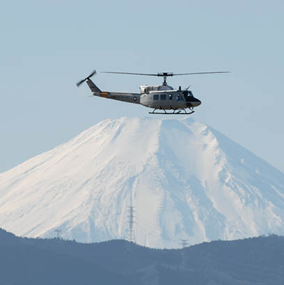 An UH-1N Iroquois with the 459th Airlift Squadron flies over Yokota Air Base, Japan, during a routine sortie Jan. 9, 2019. UH-1Ns are primarily used at Yokota for humanitarian support, DV missions, bilateral training missions, and search and rescue capabilities. (U.S. Air Force photo by Yasuo Osakabe)