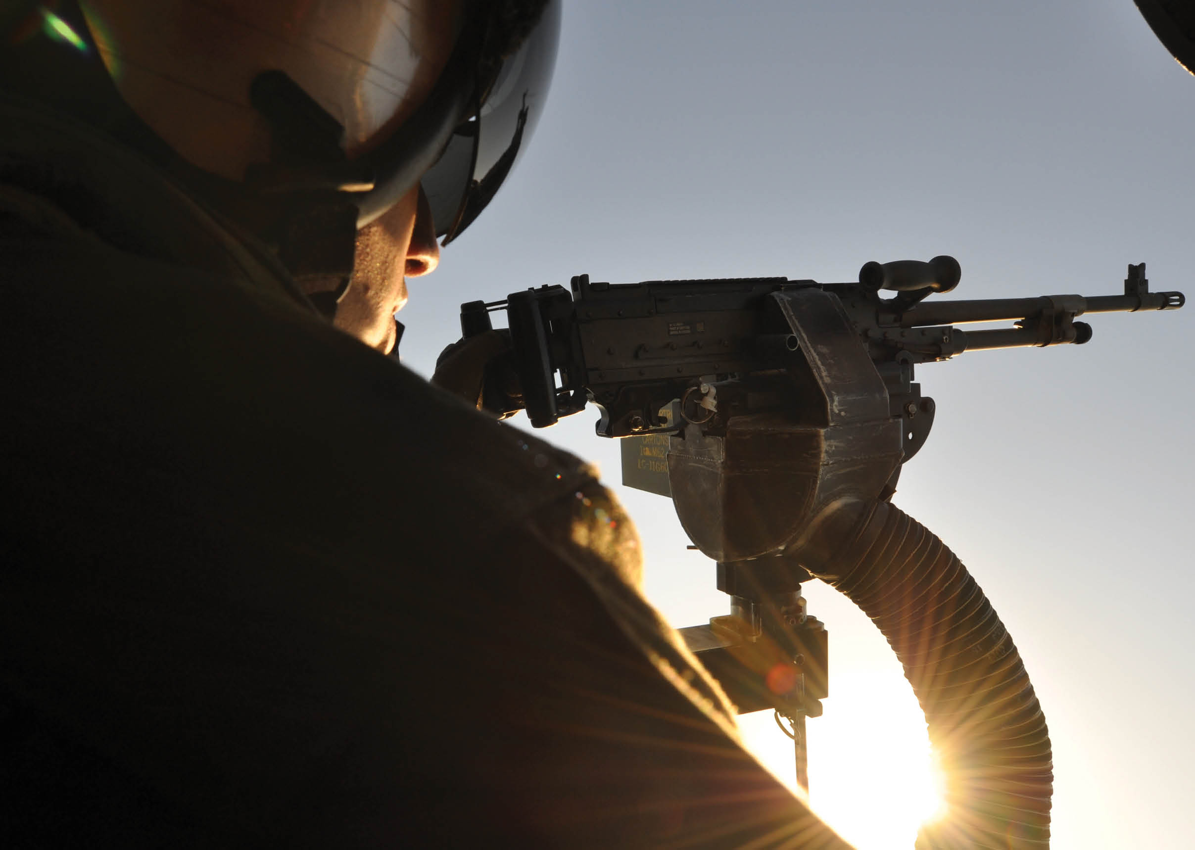 U.S. Navy Naval Aircrewman 2nd Class Stuart Thompson, assigned to Helicopter Sea Combat Squadron (HSC) 9, prepares to fire an M240D machine gun aboard an MH-60S Seahawk helicopter in Norfolk, Va., Nov. 26, 2012. HSC-9 is conducting helicopter maneuvers and live-fire exercises as part of regularly scheduled training. (U.S. Navy photo by Mass Communication Specialist 2nd Class Timothy Walter/Released)