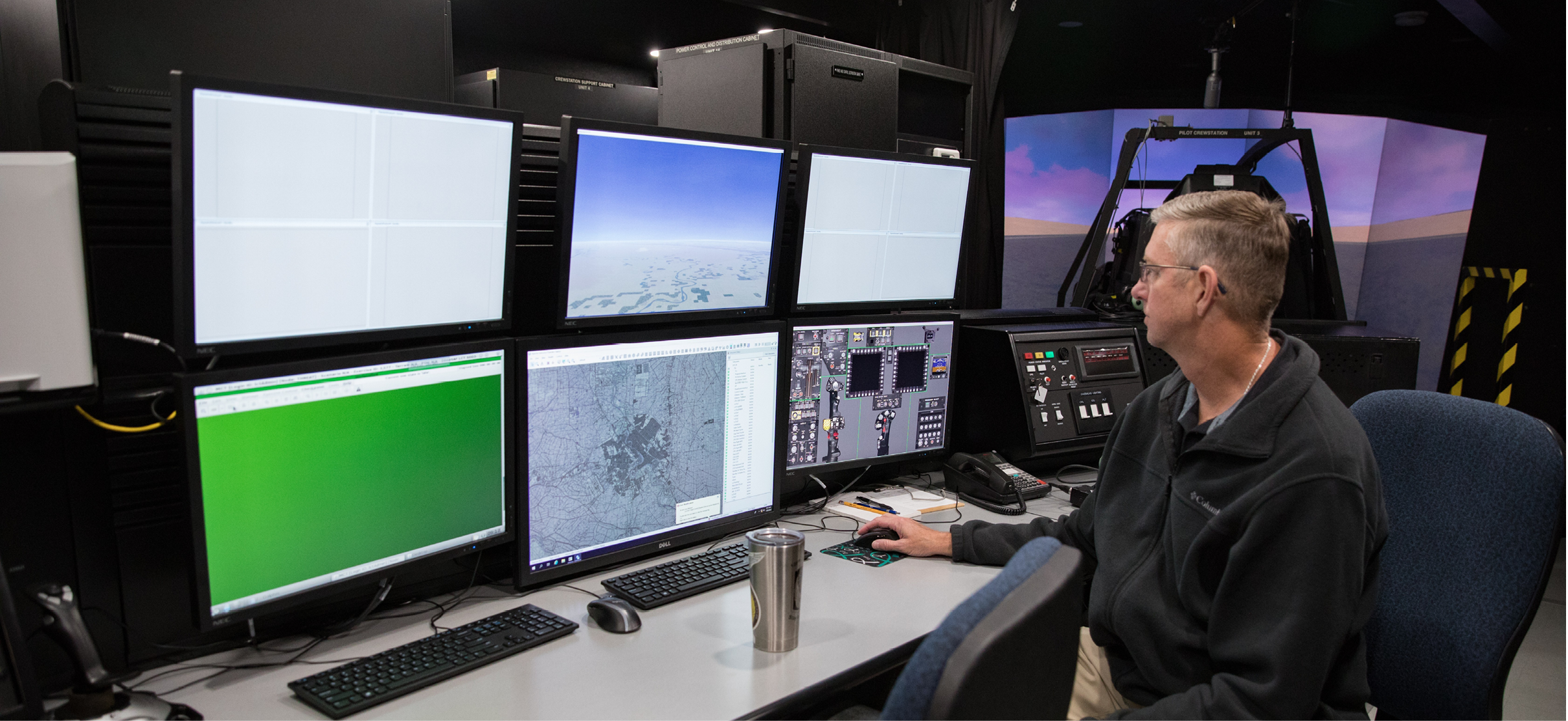 A man is sitting in front of a computer with multiple screens. AI generated content