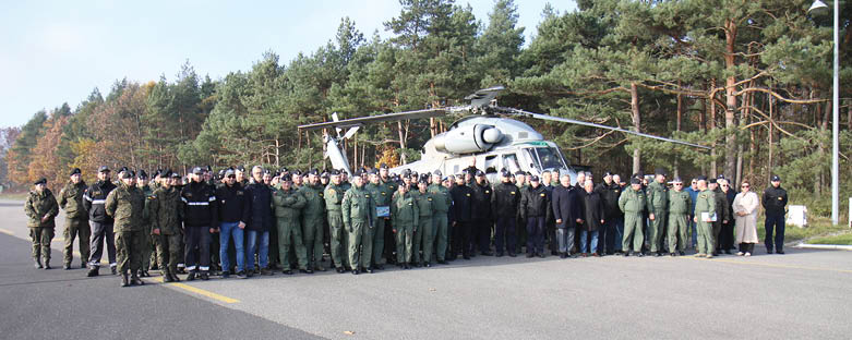 A group of people in uniform pose in front of a helicopter. AI generated content