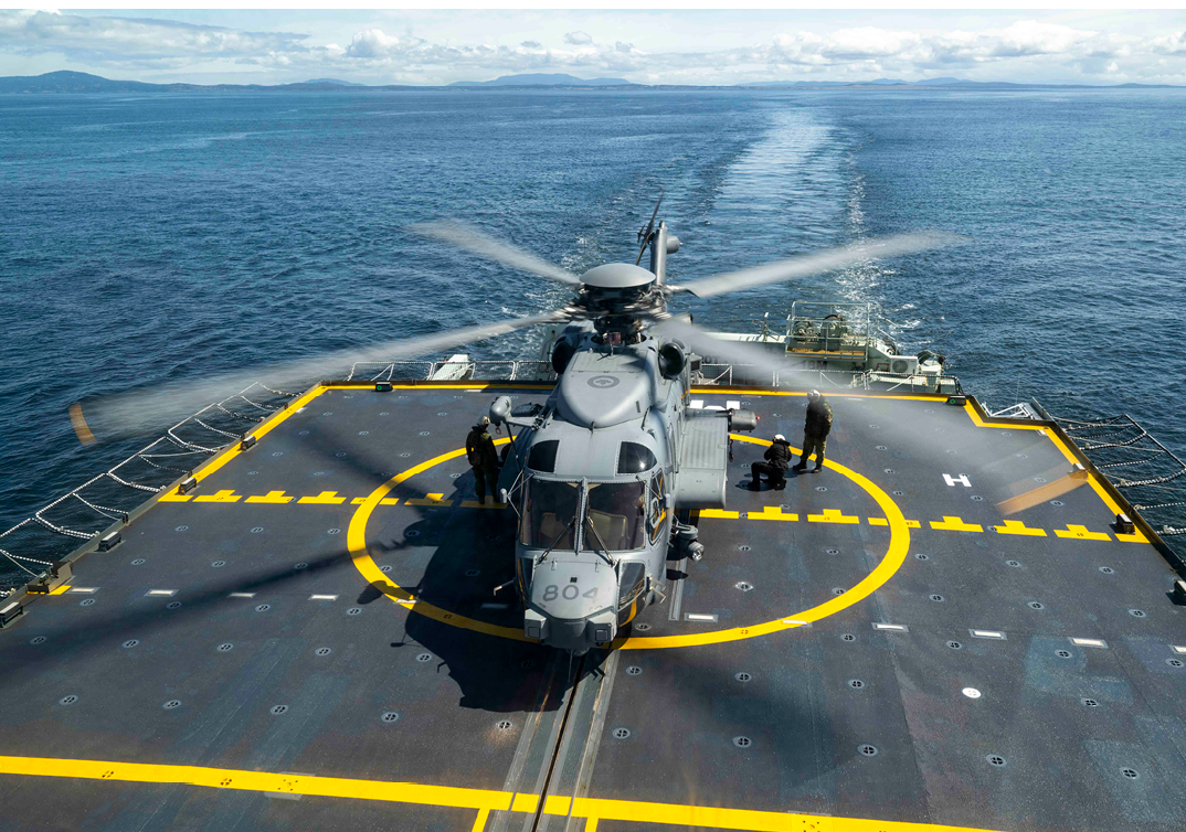 A helicopter is on a boat with a yellow circle on the deck. AI generated content