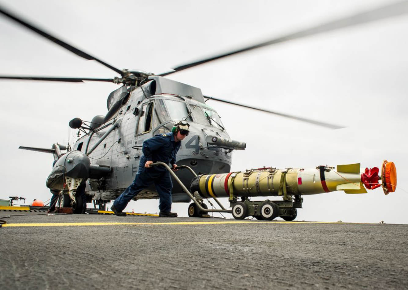 A man is working on a helicopter, attaching a missile to it. AI generated content