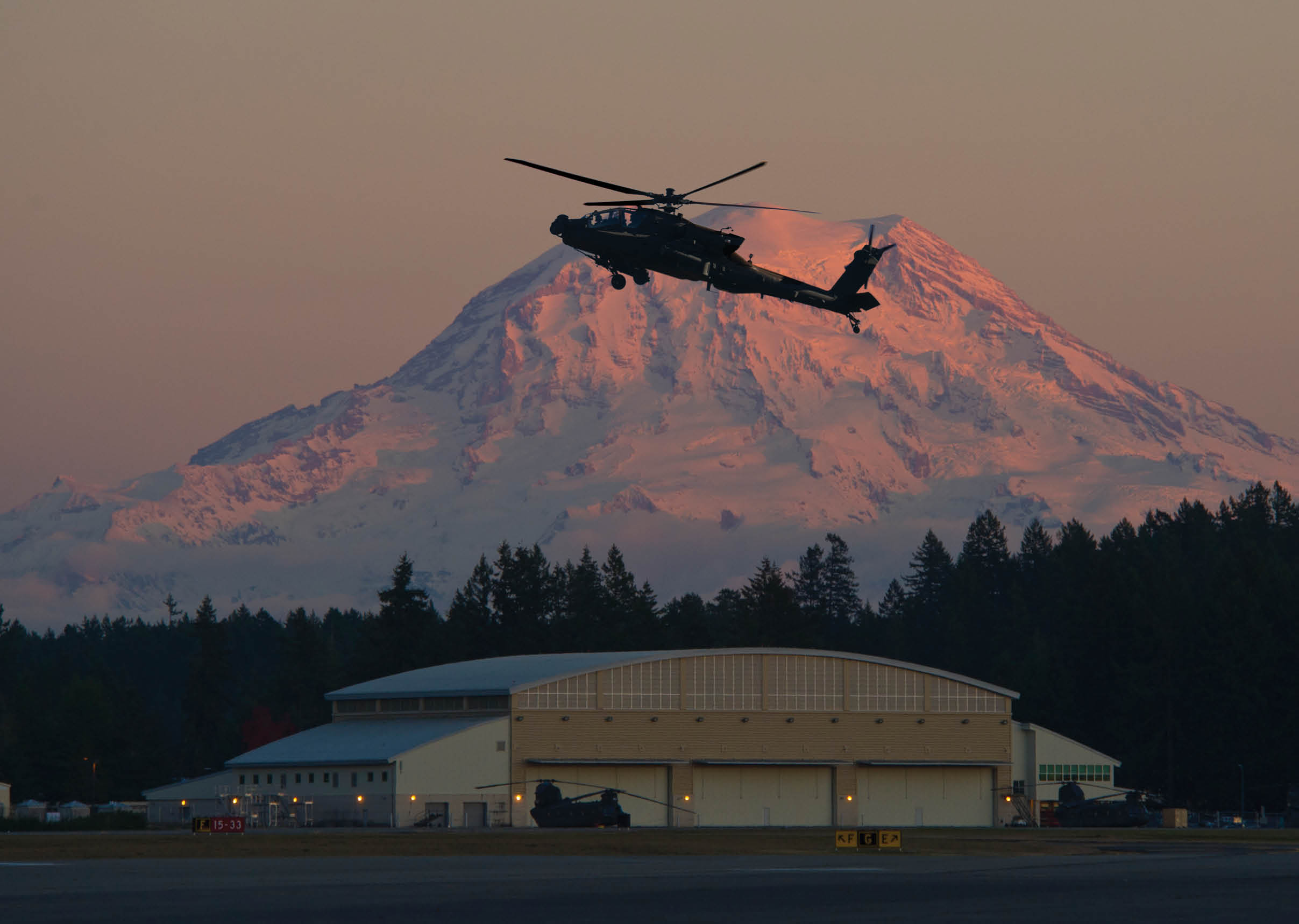 A helicopter is flying over a mountain with a building in the foreground. AI generated content