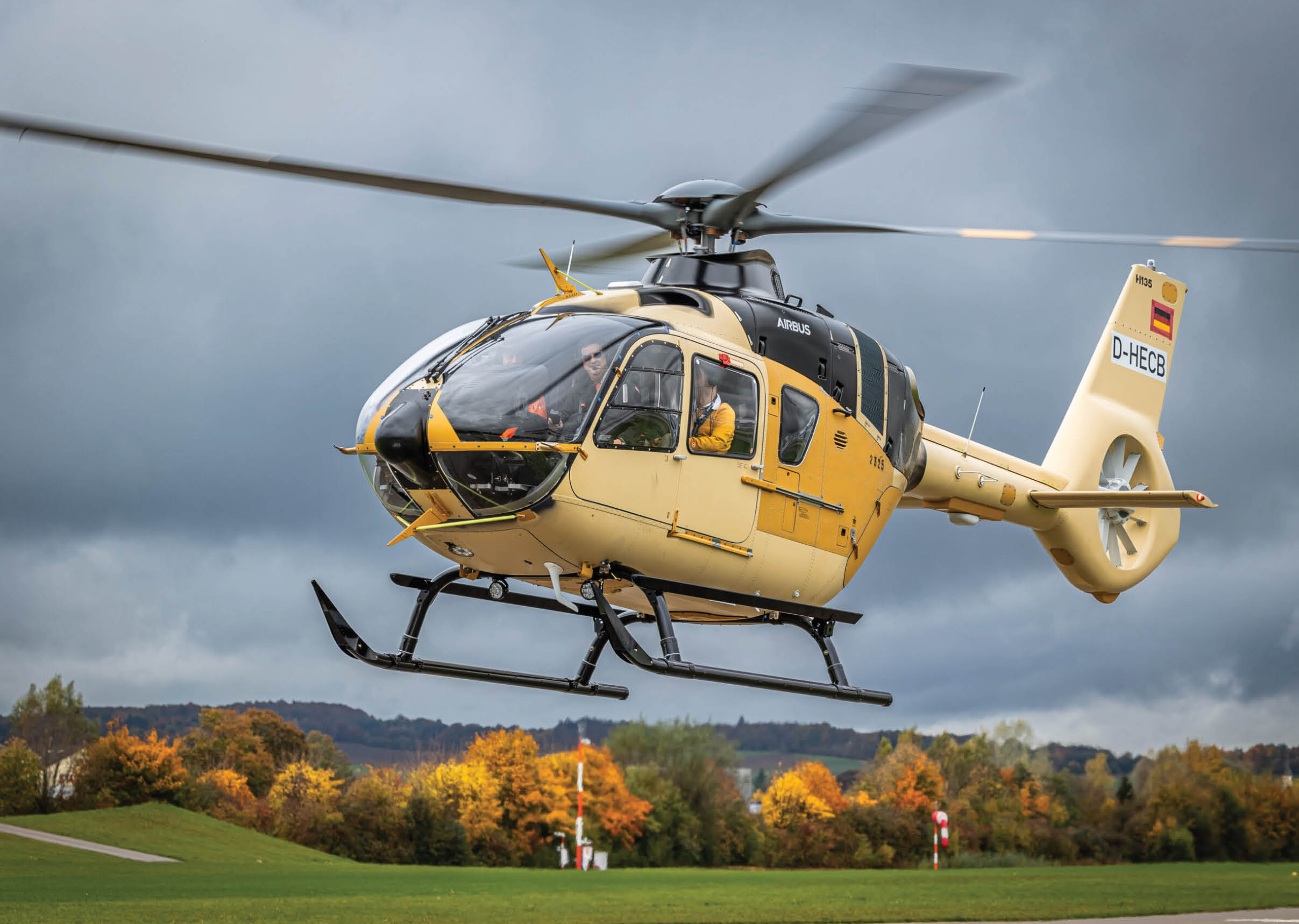 A yellow helicopter is flying in the air with its landing gear down. AI generated content