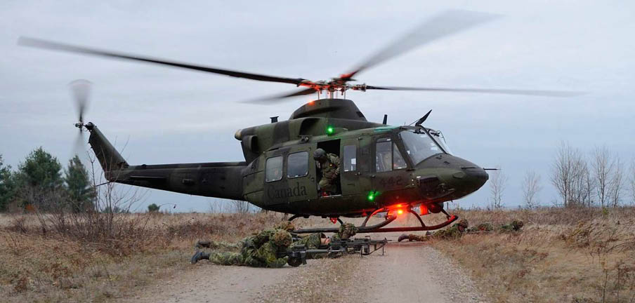 A helicopter is parked on a dirt road, with a person standing nearby. AI generated content