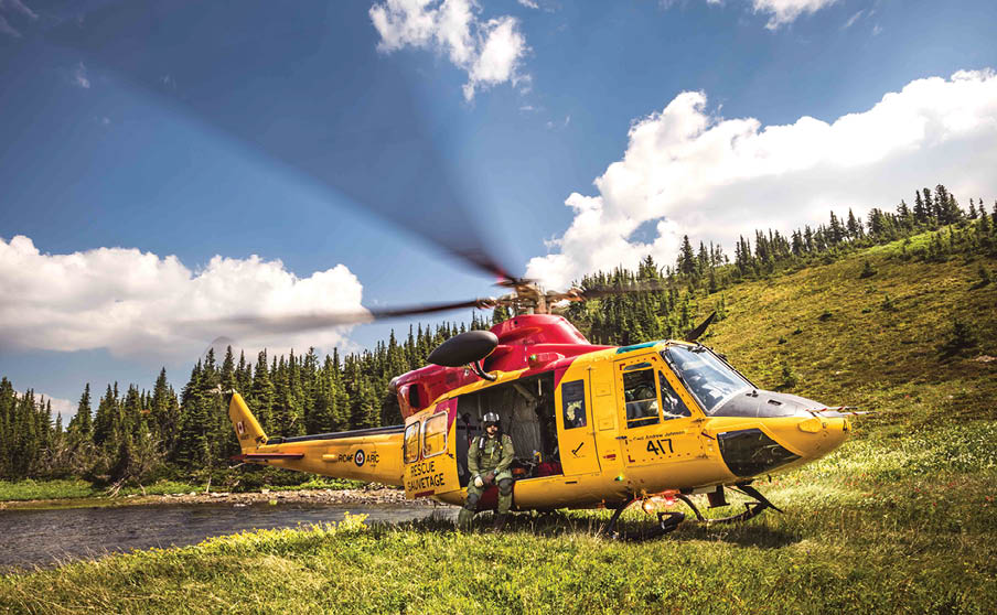 A yellow helicopter with a red top is parked on a grassy field. AI generated content