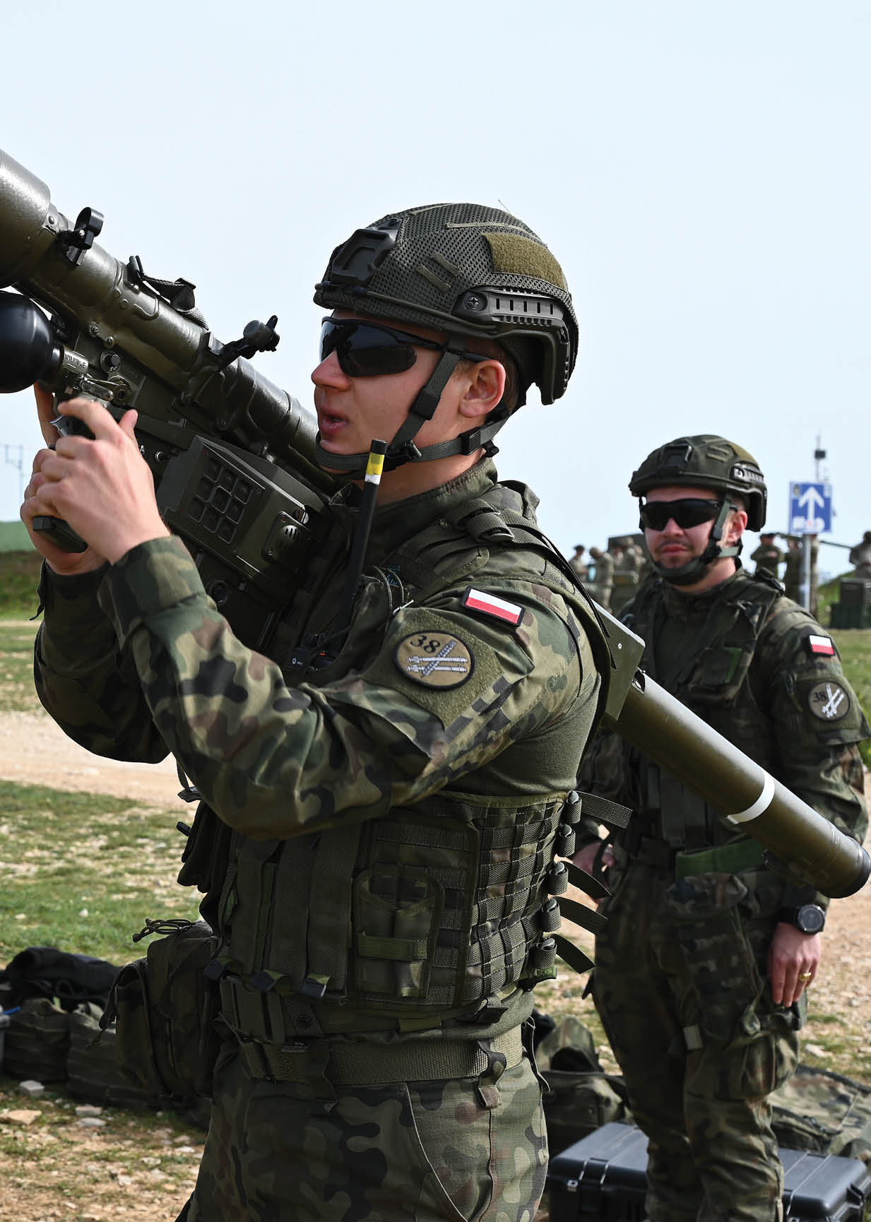 A group of soldiers are standing in a field, with one man holding a large gun. Another man is pointing the gun at the camera. AI generated content