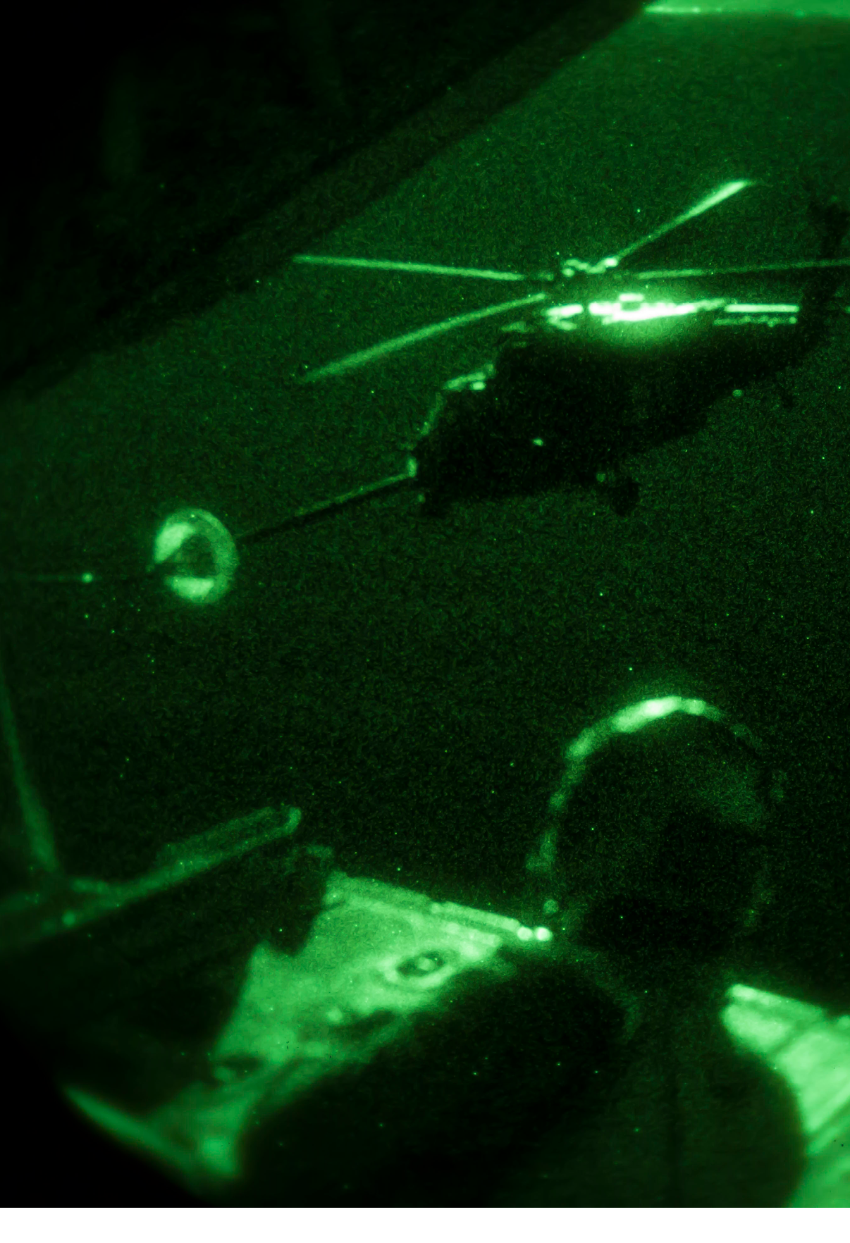 A person is sitting in a vehicle with a green glow, and a helicopter is flying above them. AI generated content