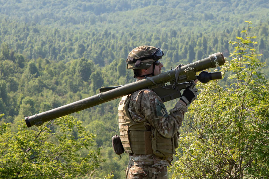 A man in camouflage is holding a large gun. AI generated content