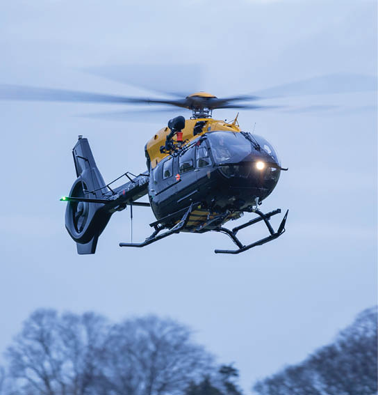 A helicopter with a yellow top is flying in the air. AI generated content