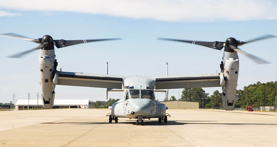 Two helicopters are parked on the ground, one in front of the other. AI generated content