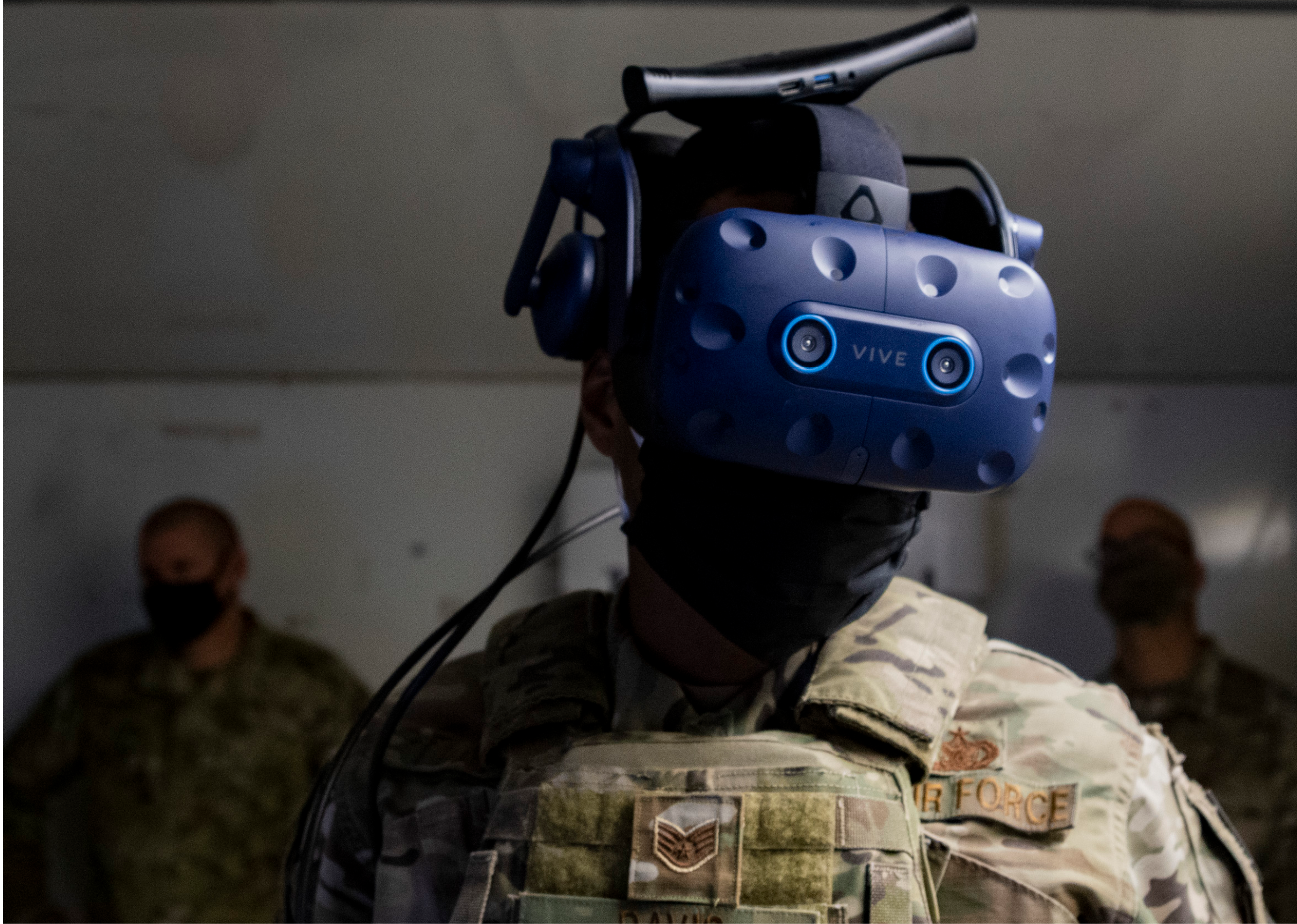 A man wearing a helmet with a camera on it is standing in a room with other men. AI generated content