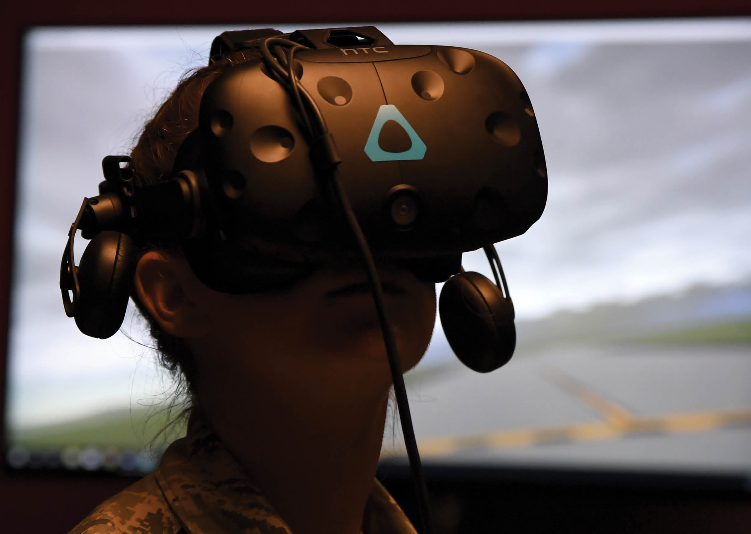 A person wearing a military uniform is playing a video game using a virtual reality headset. AI generated content