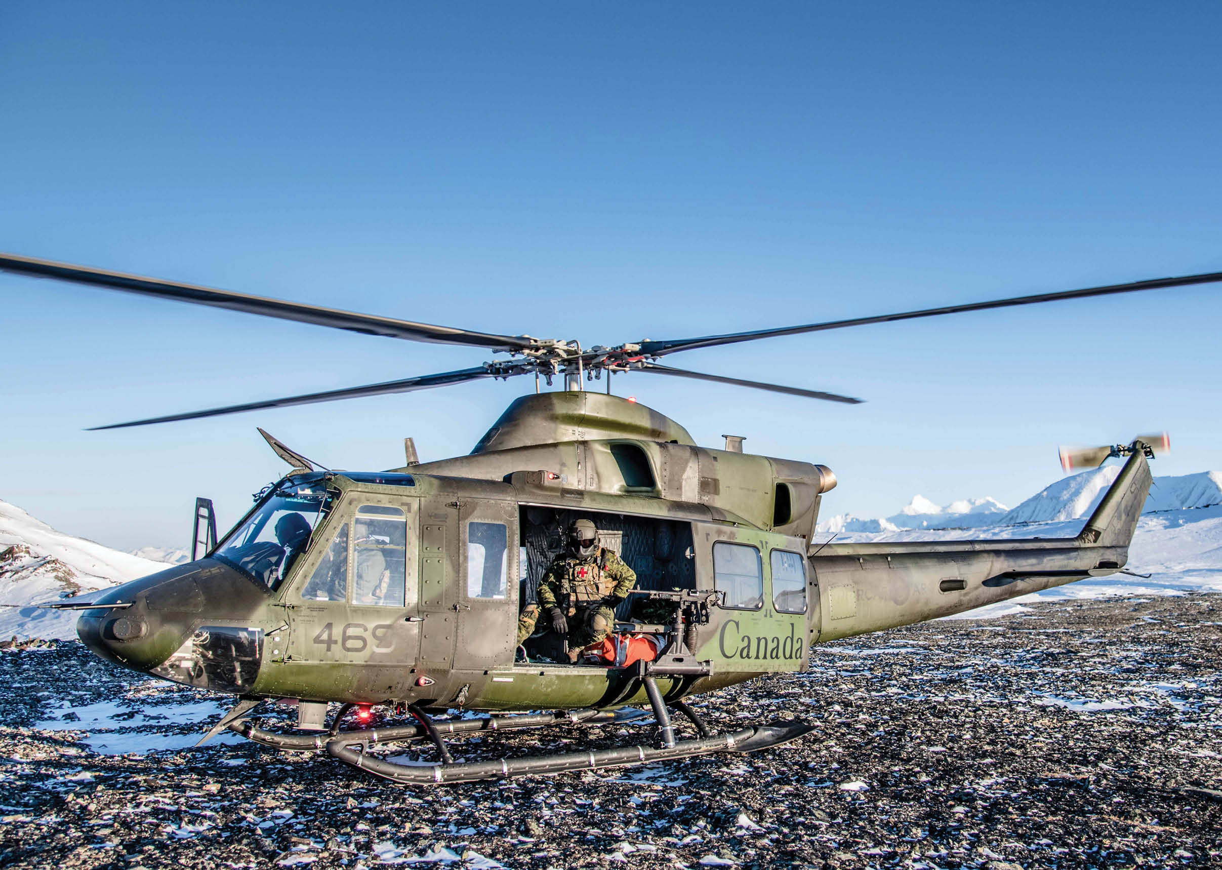 A helicopter is parked on a rocky surface, with a man standing in the doorway. AI generated content