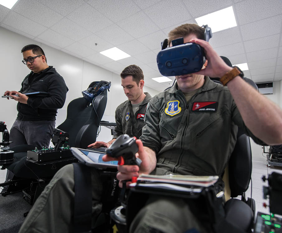 Two men wearing military uniforms are sitting in chairs, using virtual reality goggles. AI generated content