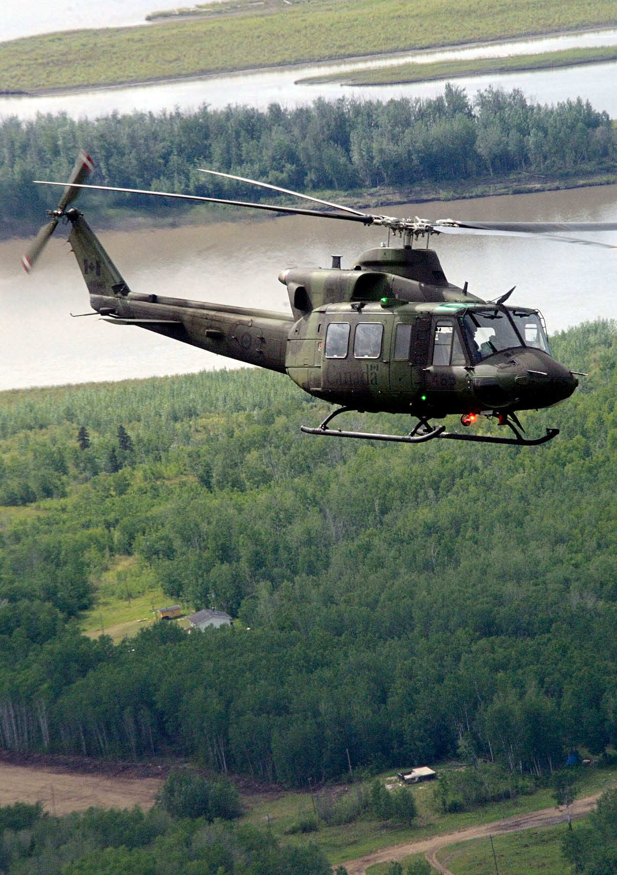 A helicopter is flying over a forest and a body of water. AI generated content