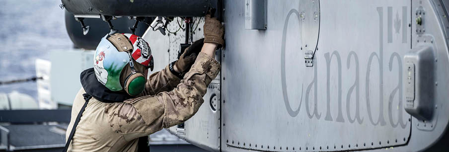 A man is working on a helicopter, attaching a missile to it. AI generated content