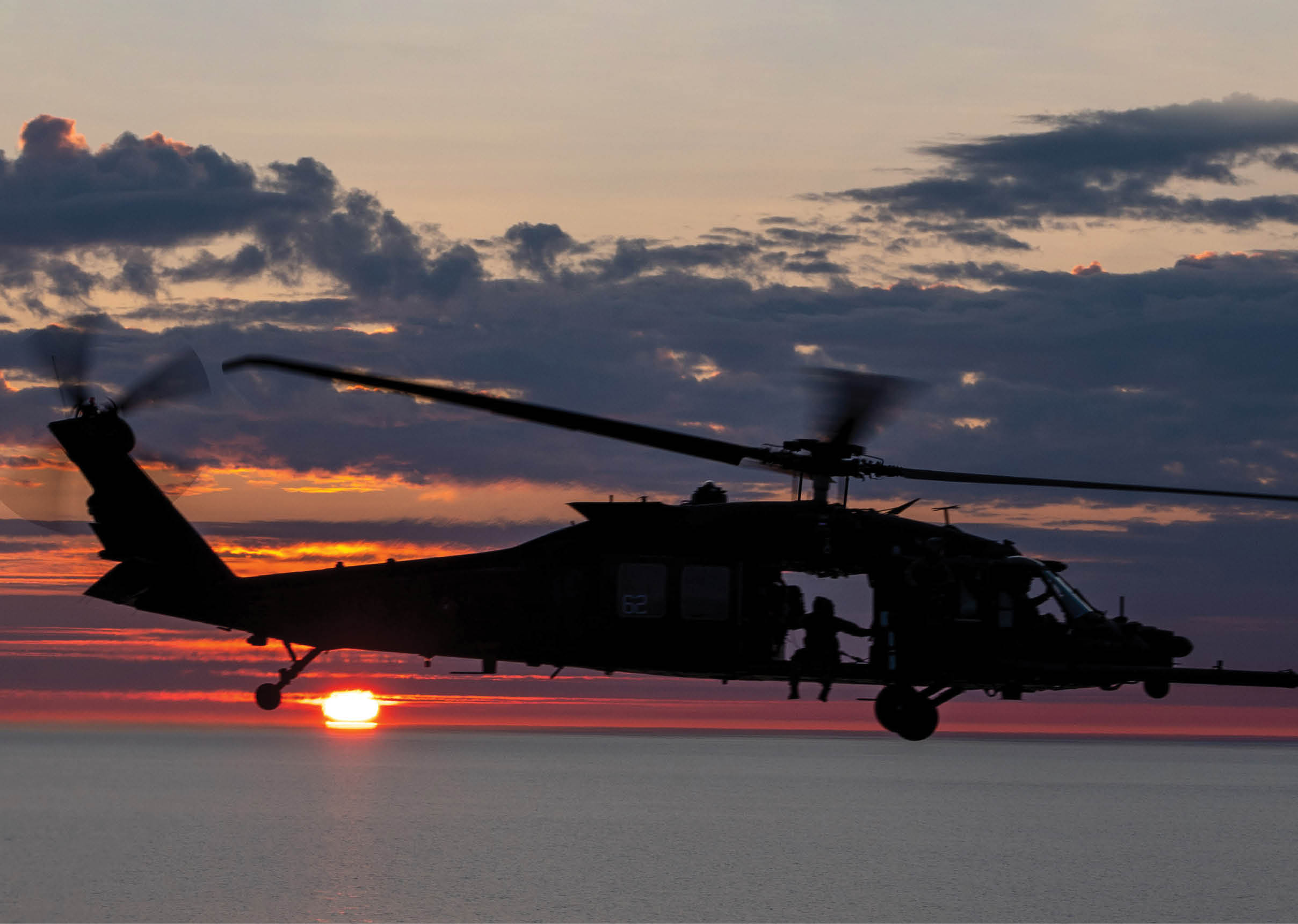 A helicopter is flying over the ocean at sunset. AI generated content
